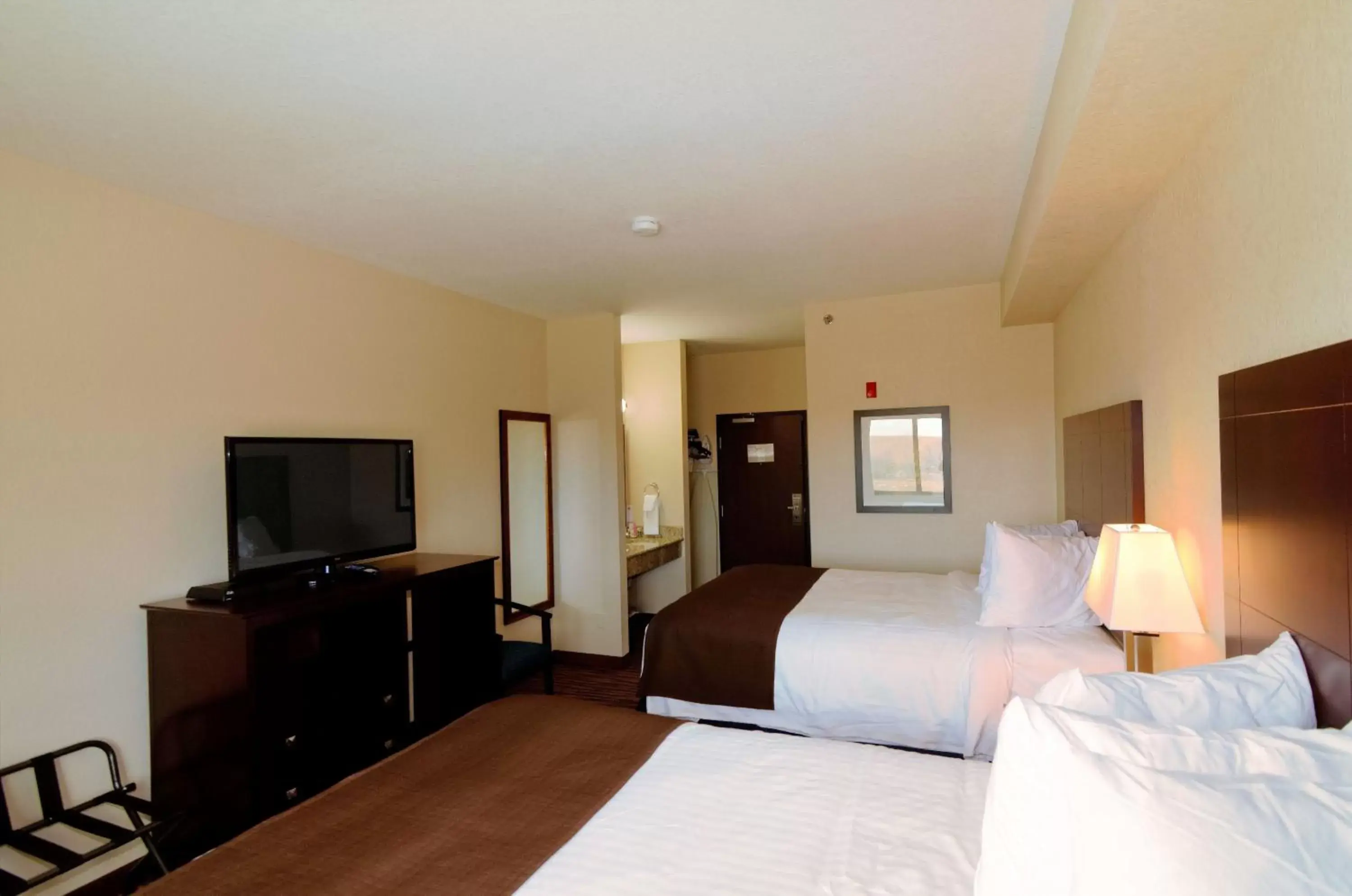 Bed, TV/Entertainment Center in Cobblestone Inn & Suites - Denison | Oak Ridge