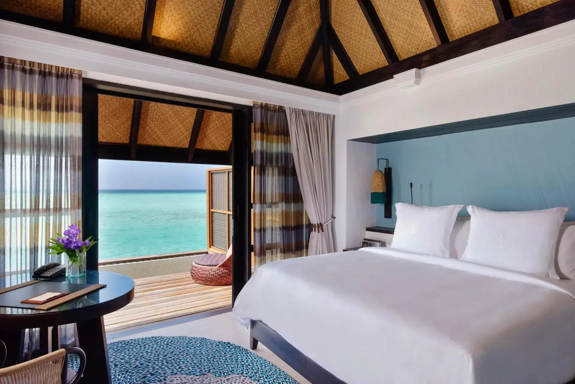 Bed, Sea View in Four Seasons Resort Maldives at Kuda Huraa