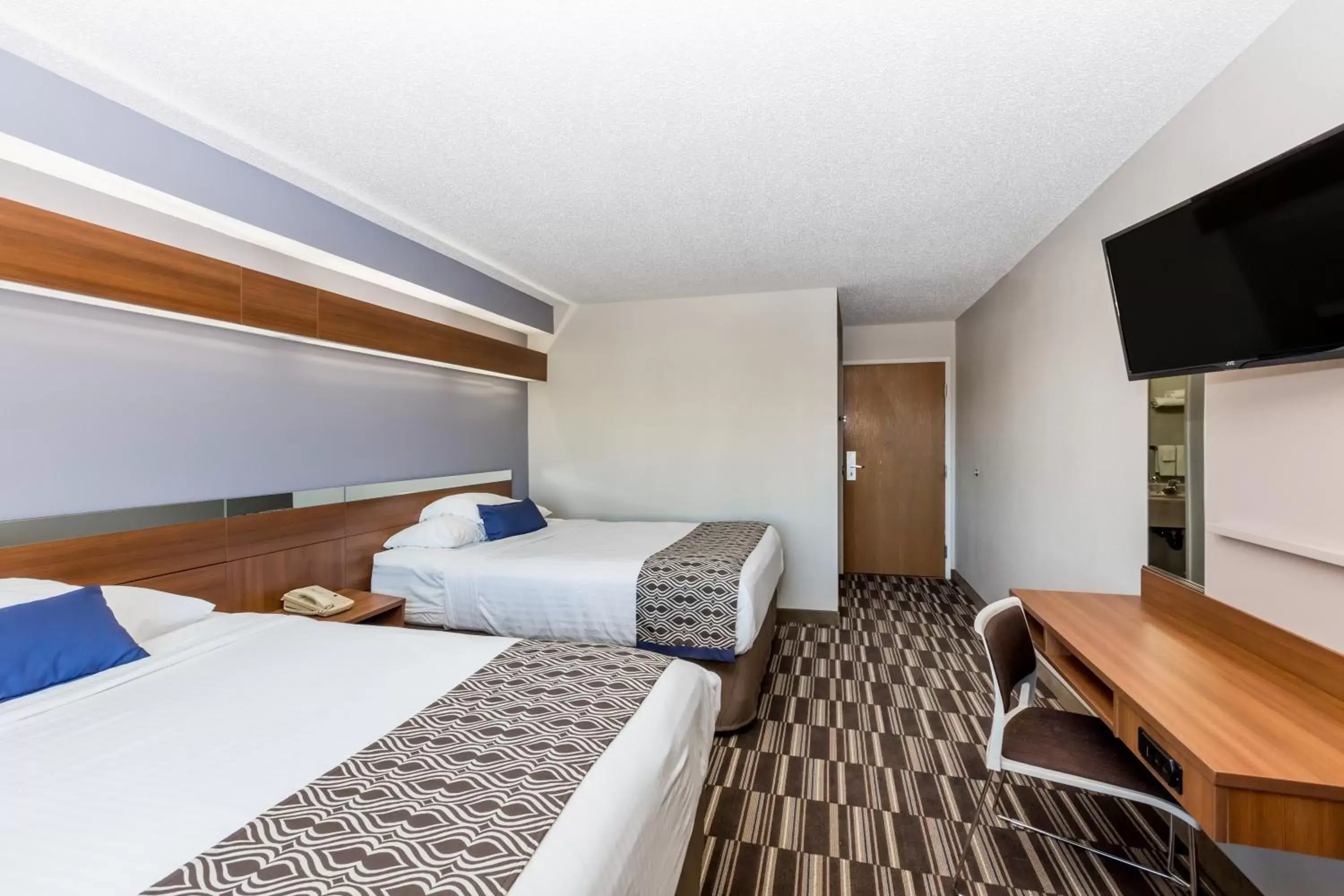 Bed in Microtel Inn & Suites by Wyndham Sioux Falls