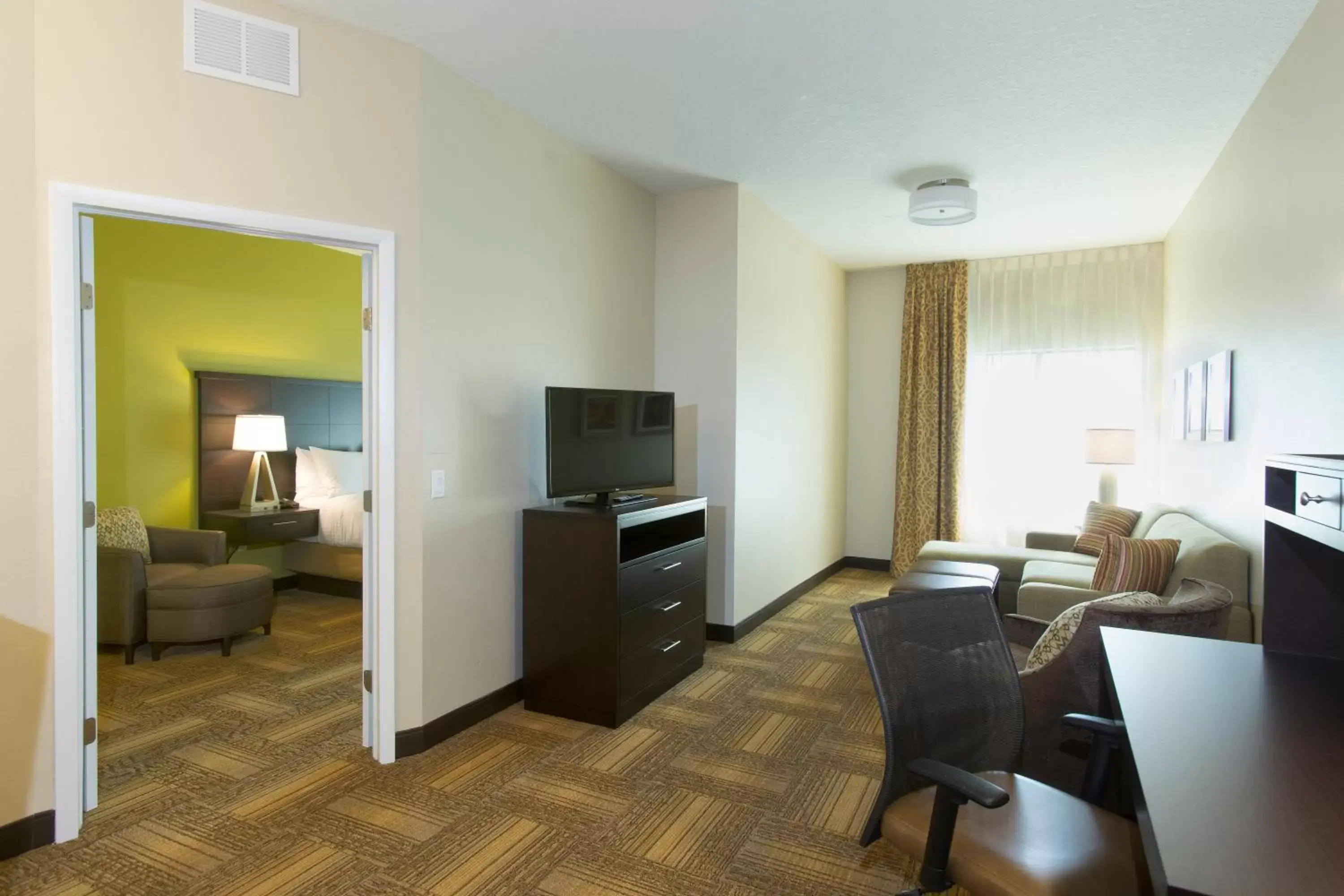 Photo of the whole room, Seating Area in Staybridge Suites Orlando at SeaWorld, an IHG Hotel