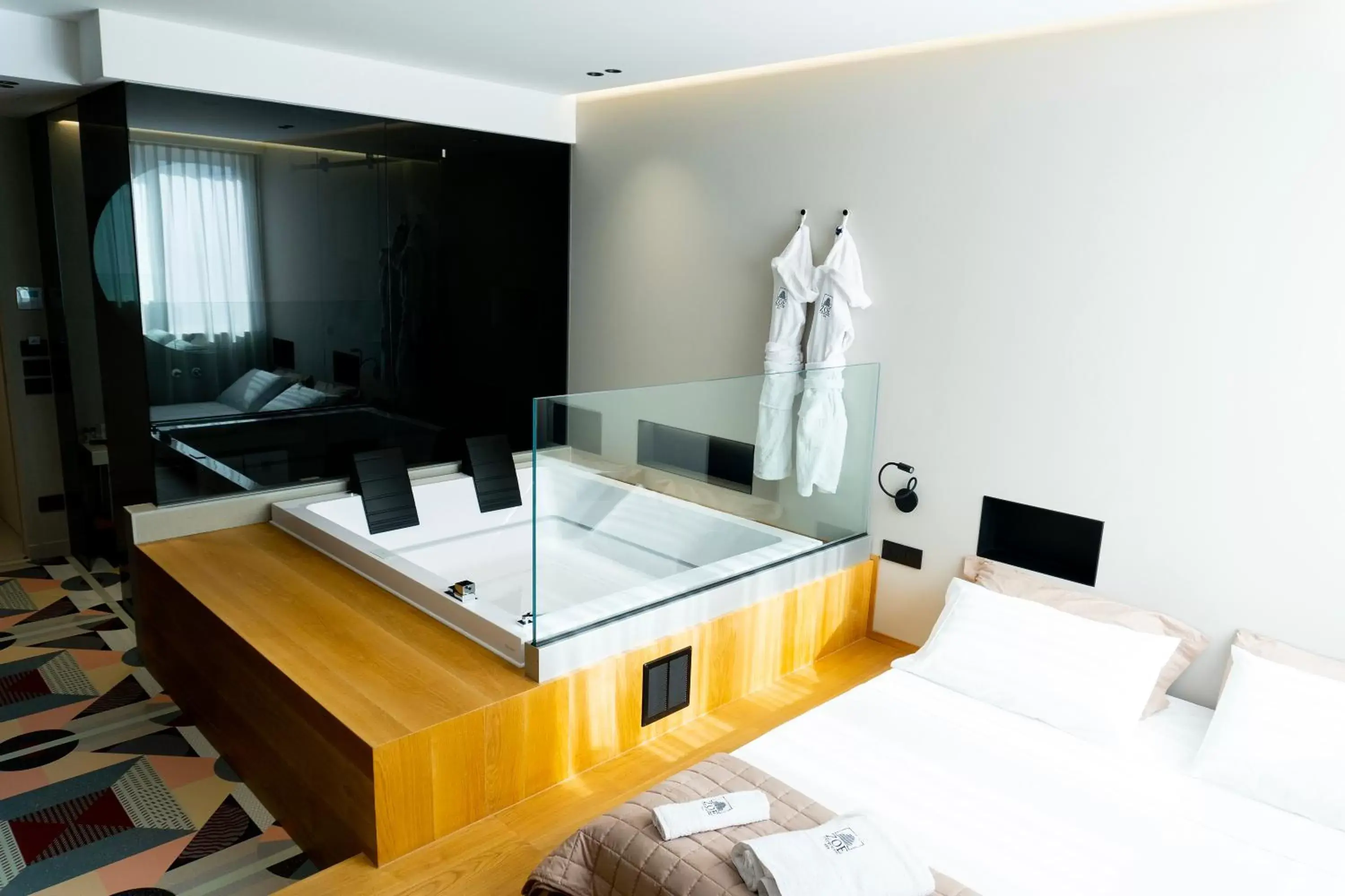 Bed, TV/Entertainment Center in ZOE LUXURY SUITES