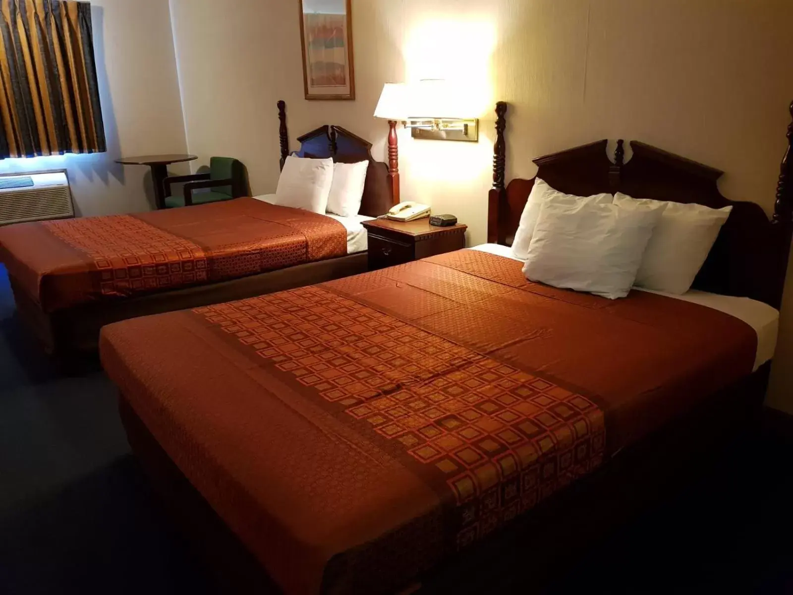 Bed in Denison Inn & Suites