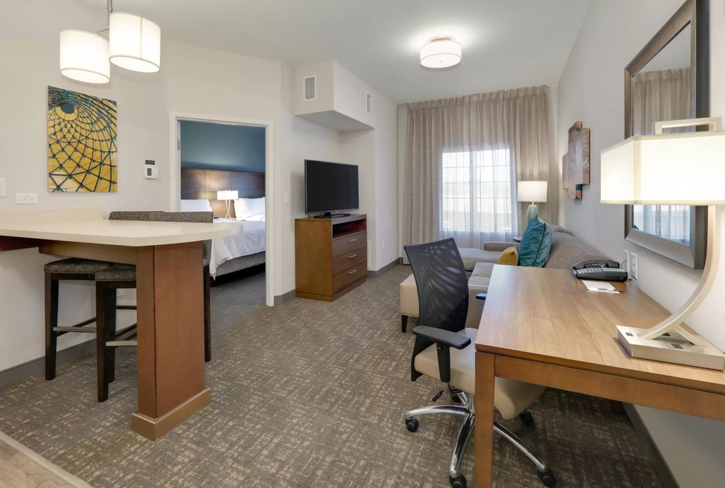 Bedroom, TV/Entertainment Center in Staybridge Suites - Oklahoma City - Downtown, an IHG Hotel