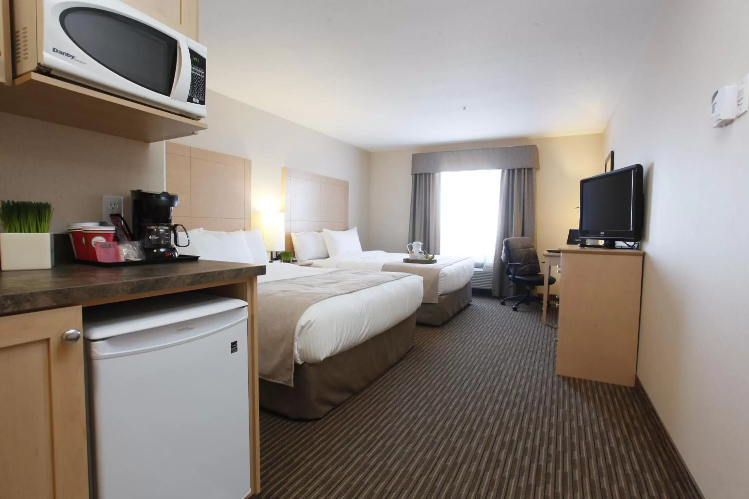 Bedroom, TV/Entertainment Center in Vegreville Suites