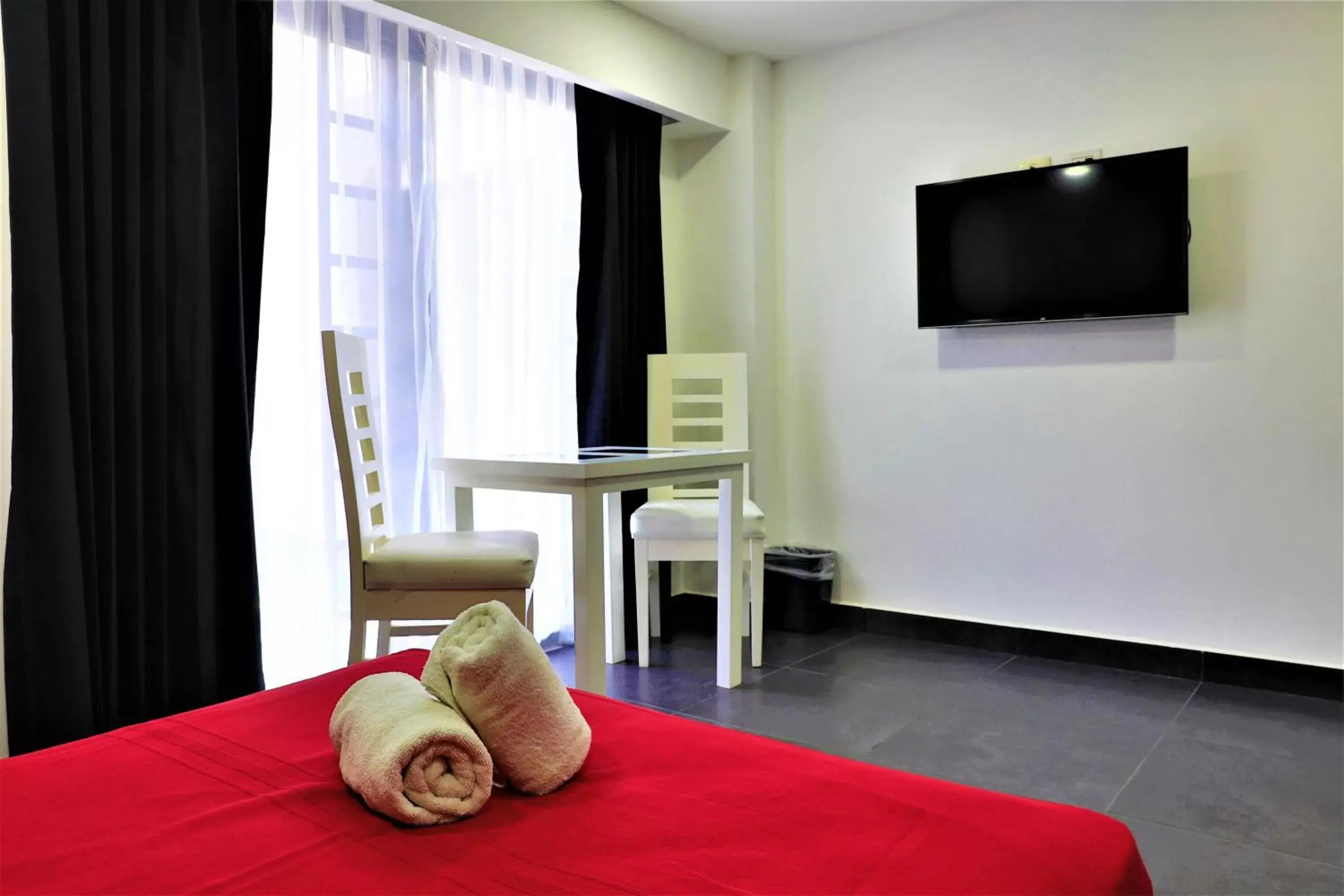 Photo of the whole room, TV/Entertainment Center in Hotel Colonial Playa del Carmen