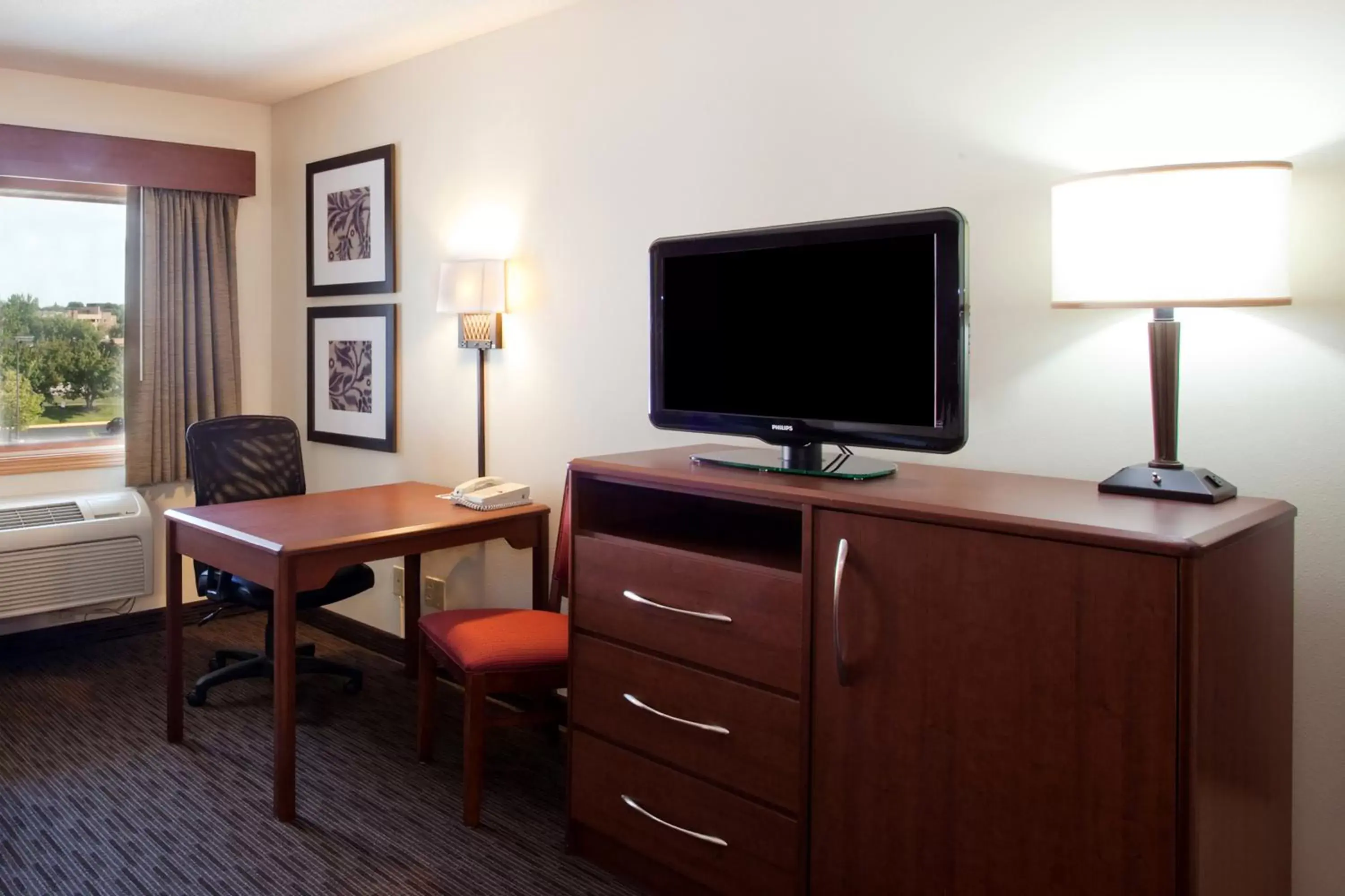 Photo of the whole room, TV/Entertainment Center in AmericInn by Wyndham Black River Falls I-94 on ATV Trail