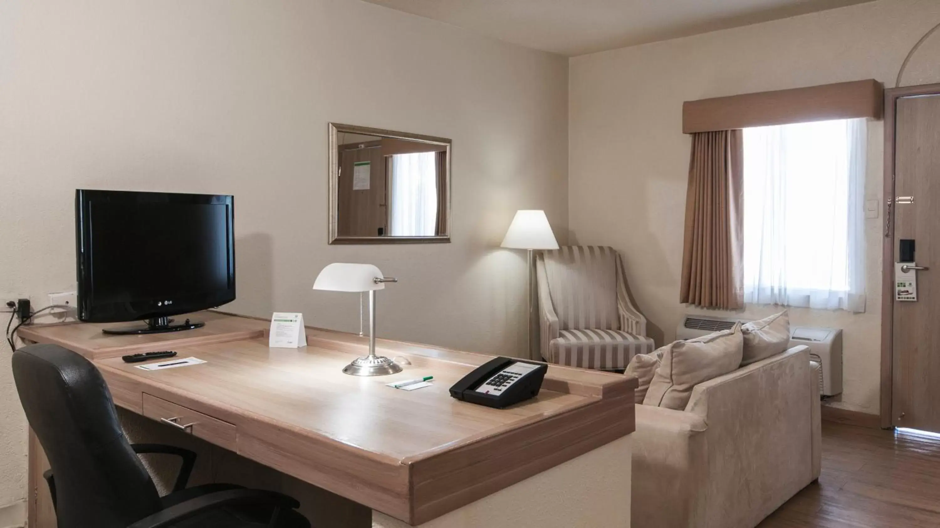 Photo of the whole room, TV/Entertainment Center in Holiday Inn Hotel & Suites Chihuahua, an IHG Hotel