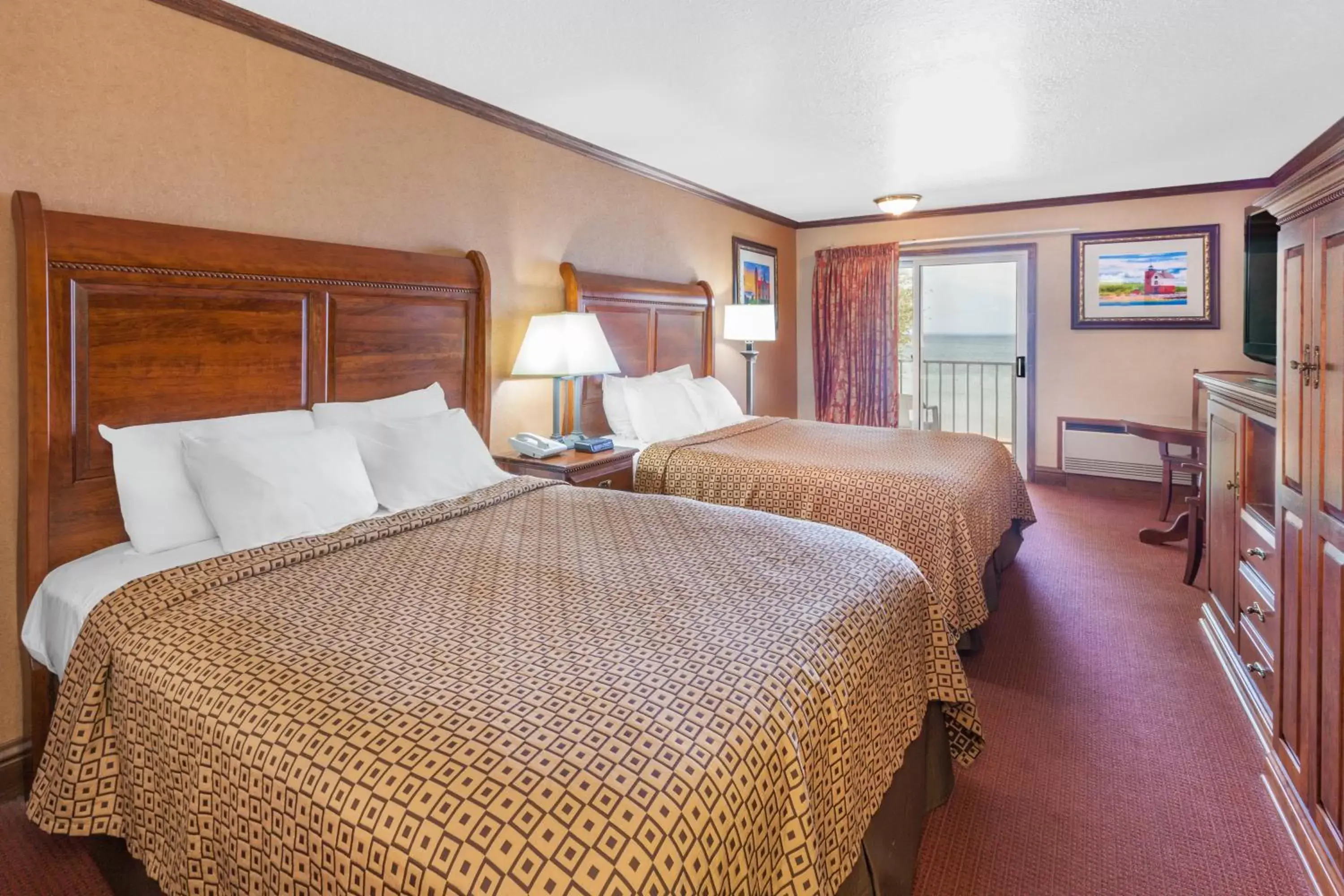 Photo of the whole room, Bed in Ramada by Wyndham Mackinaw City Waterfront