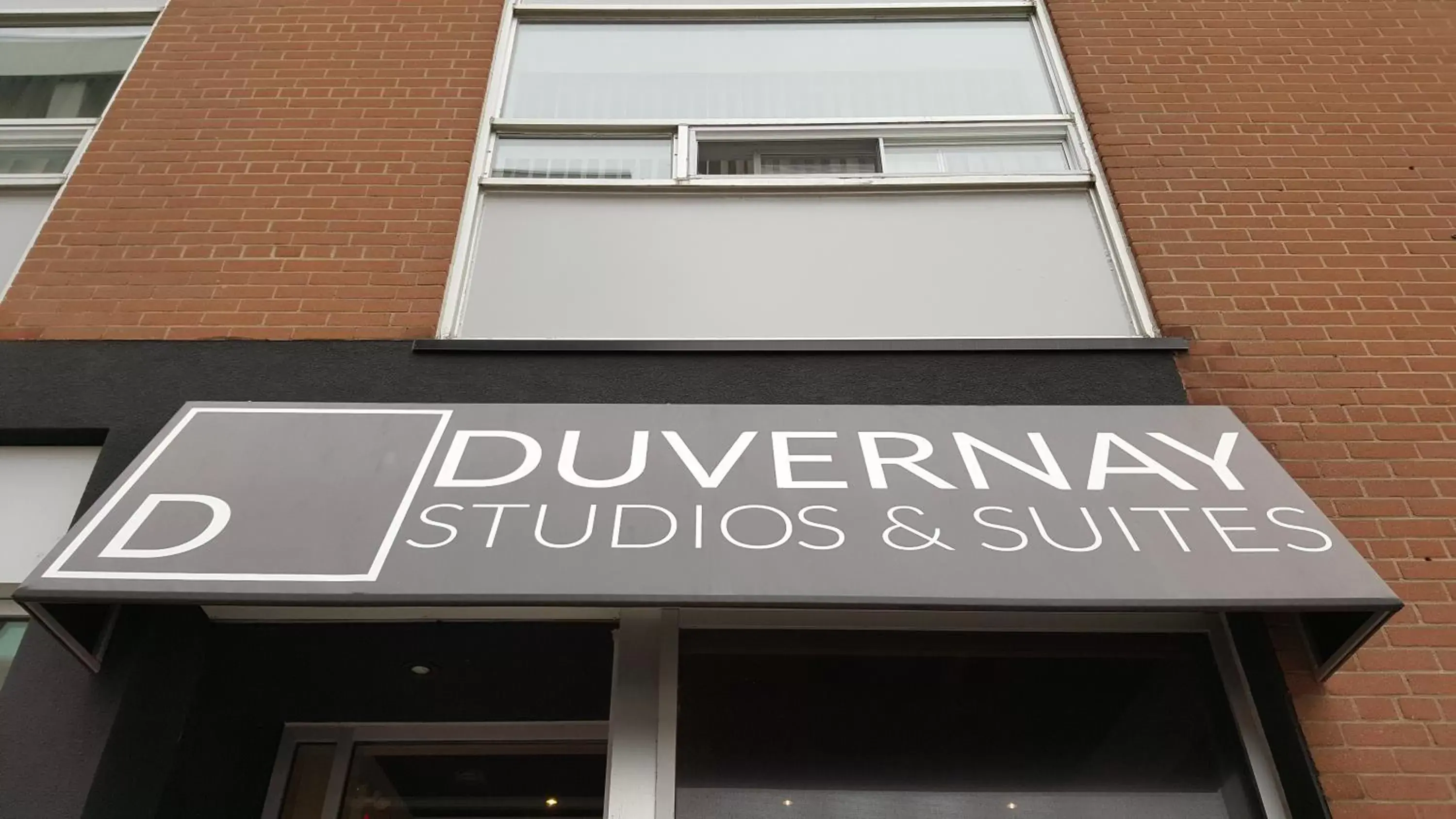 Property logo or sign in Duvernay Studios and Suites