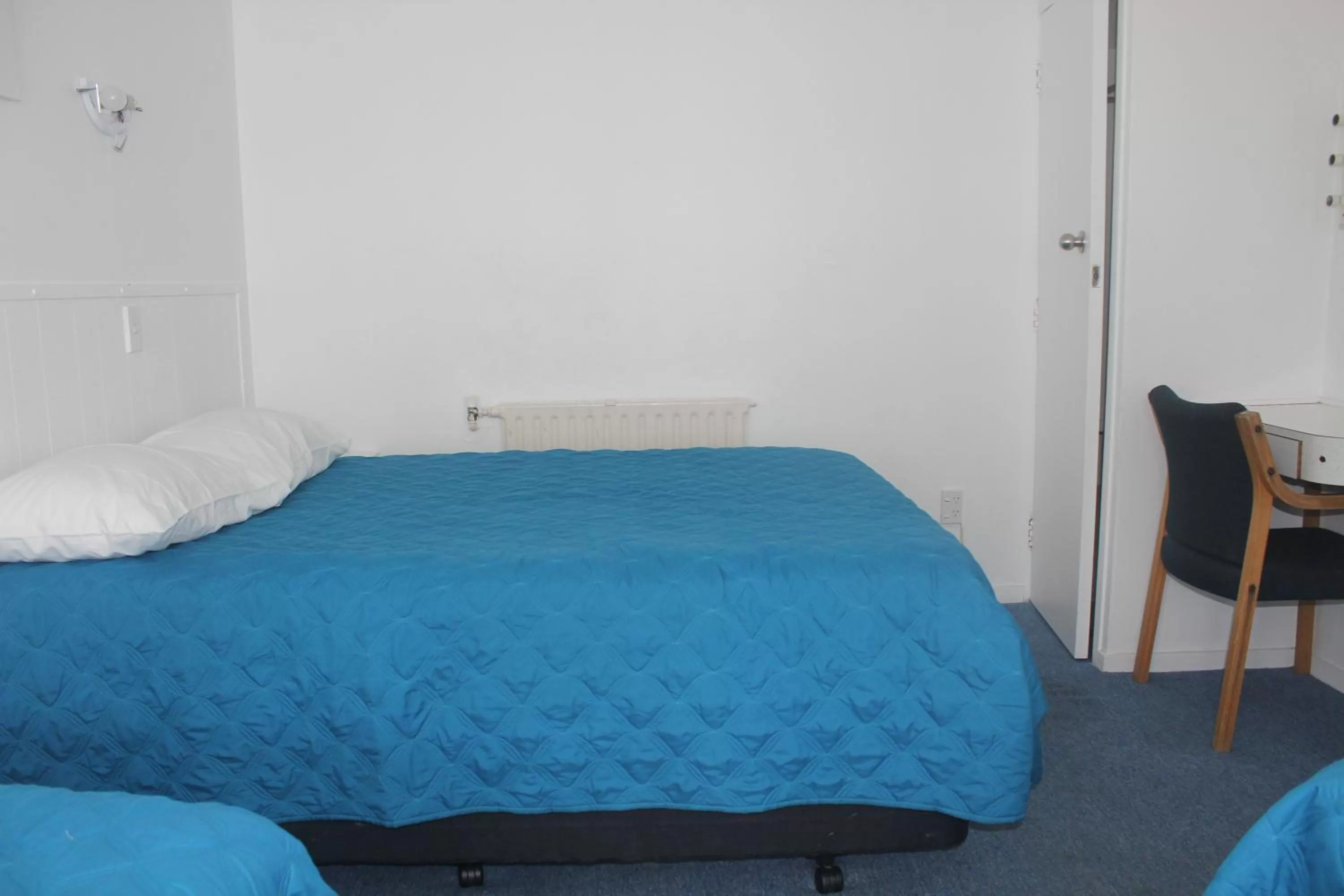 Bed in Golden Glow Motel