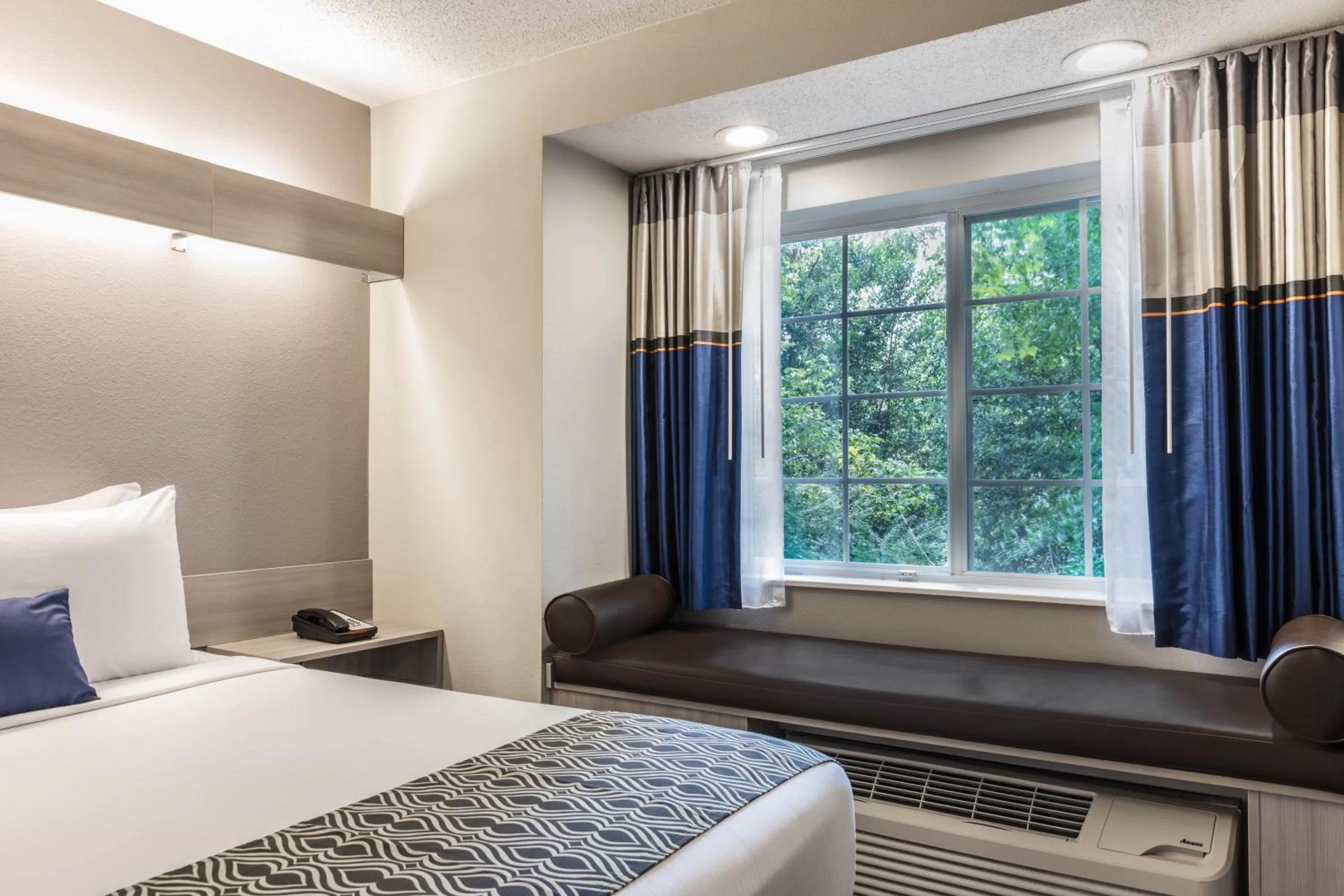 Bed in Microtel Inn & Suites by Wyndham Atlanta Buckhead Area