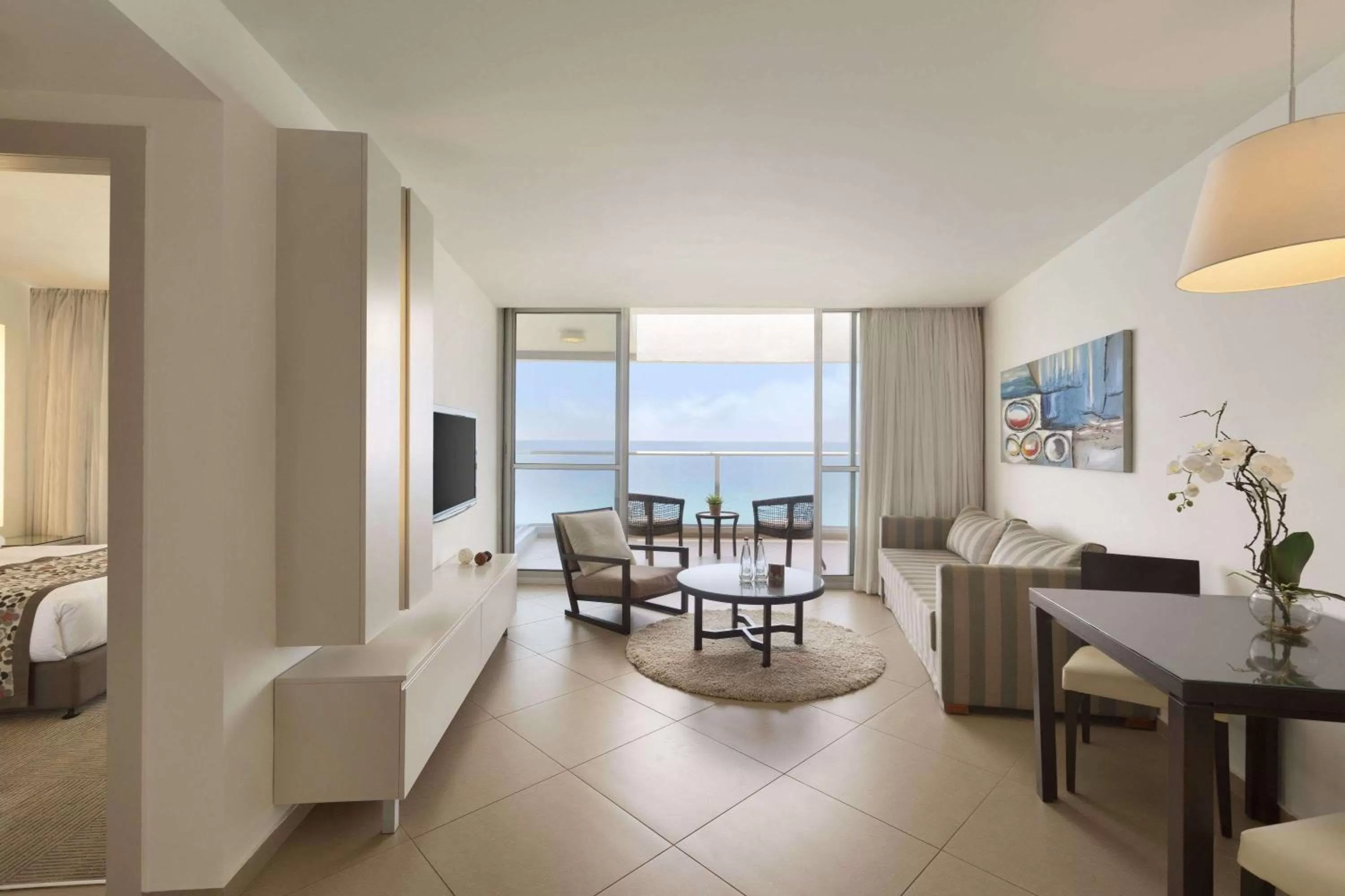 Living room, Bed in Ramada Hotel & Suites by Wyndham Netanya