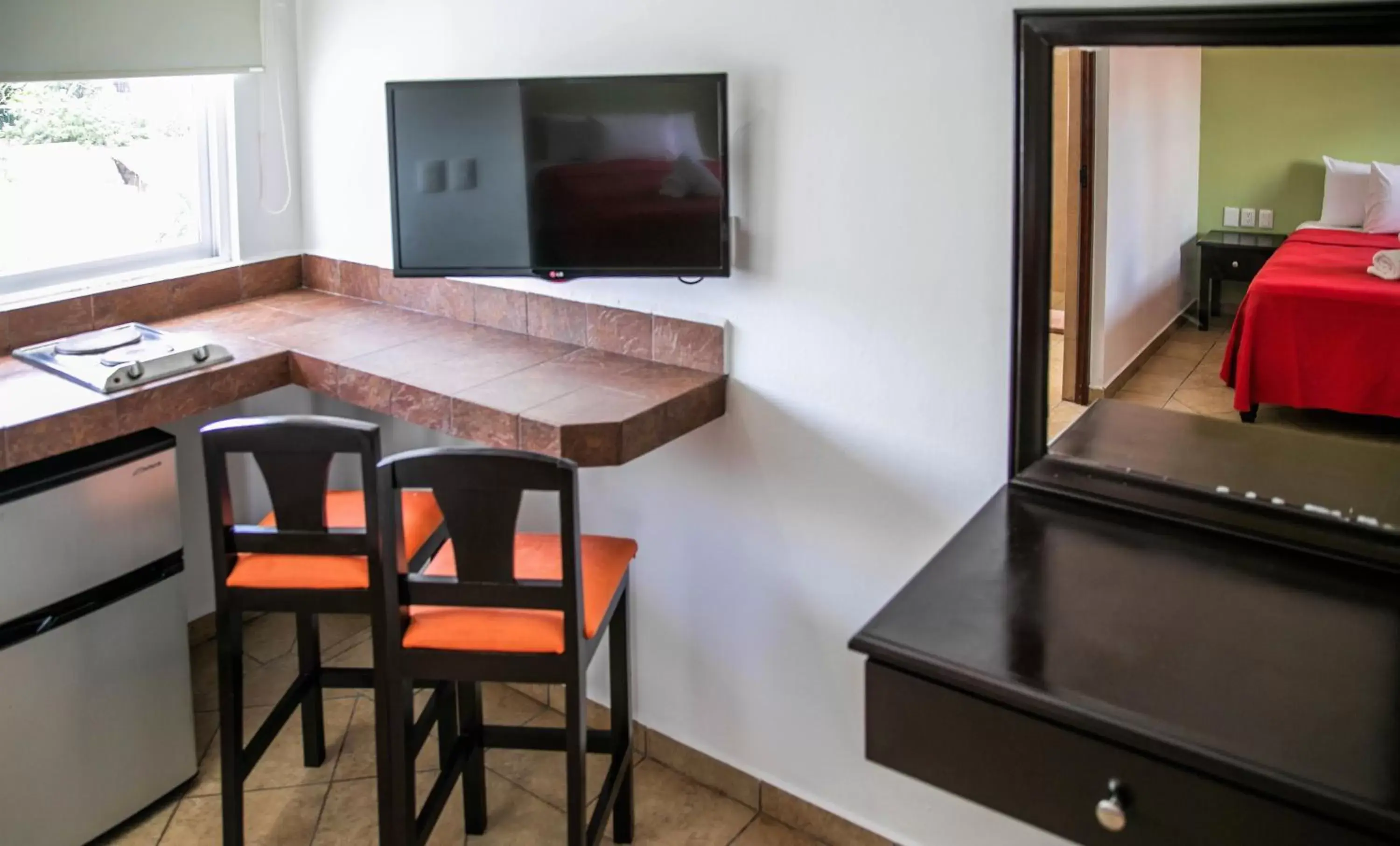 Photo of the whole room, TV/Entertainment Center in Hotel Colonial Playa del Carmen