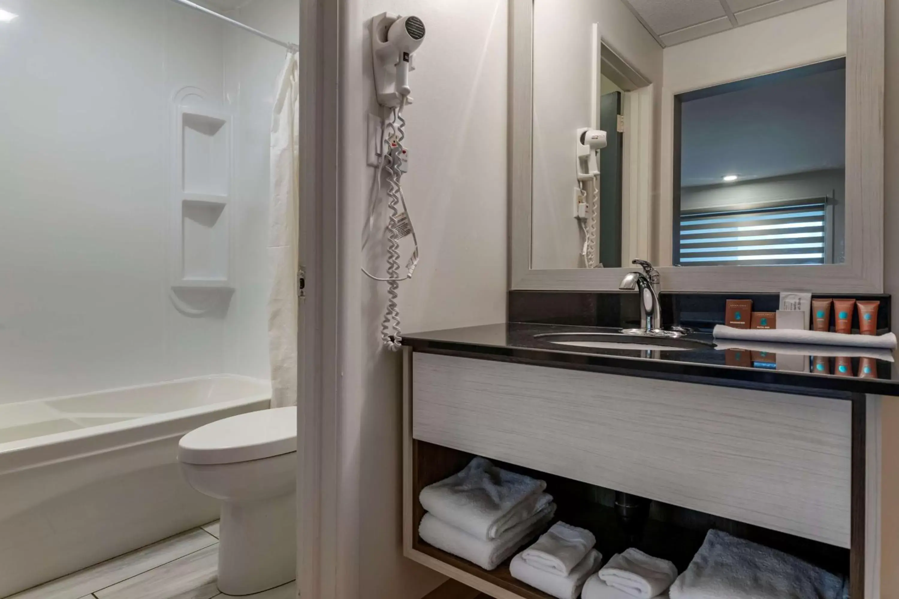 Bathroom in Dannys Hotel Suites; SureStay Collection by Best Western