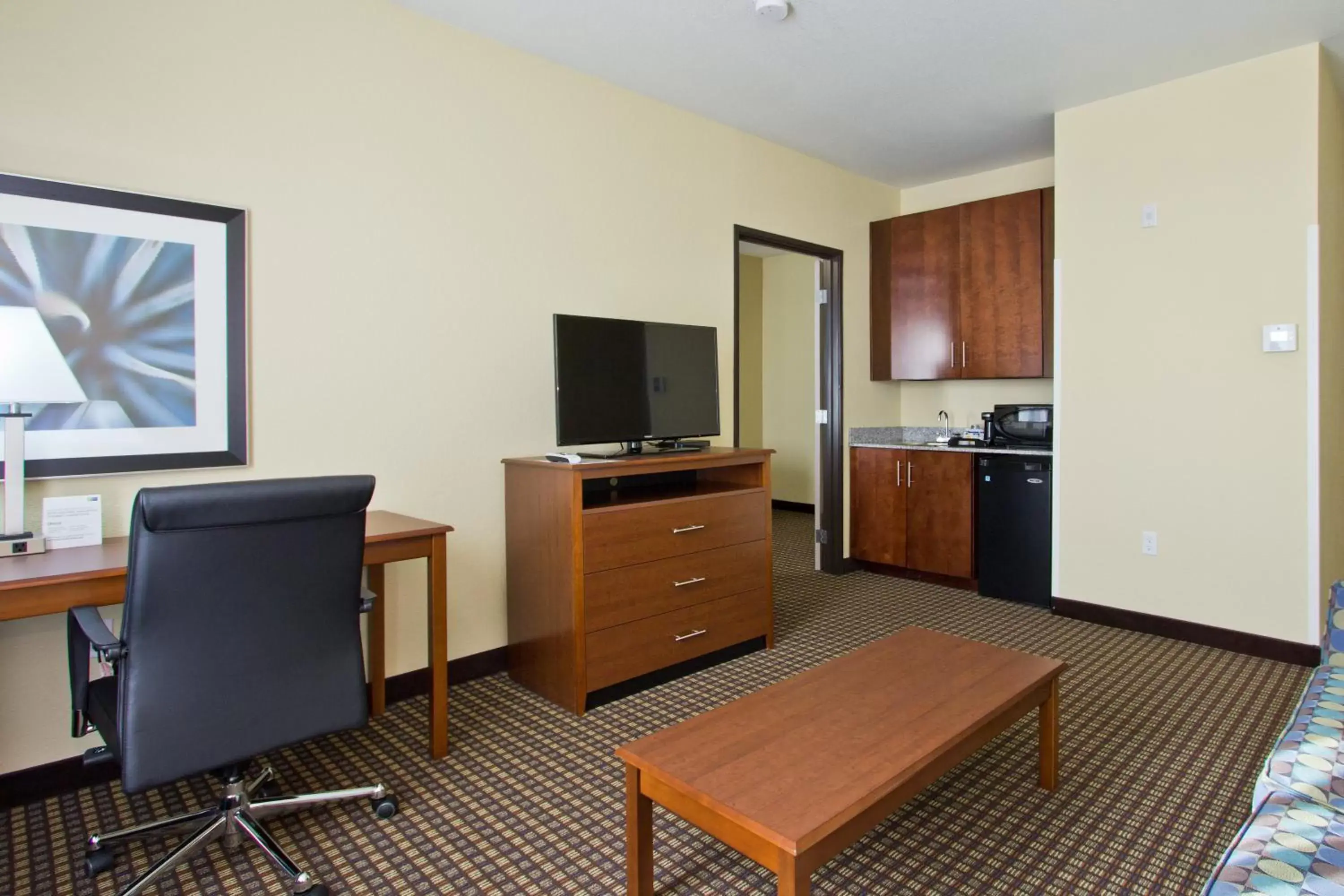 Photo of the whole room, TV/Entertainment Center in Holiday Inn Express and Suites Denver East Peoria Street, an IHG Hotel