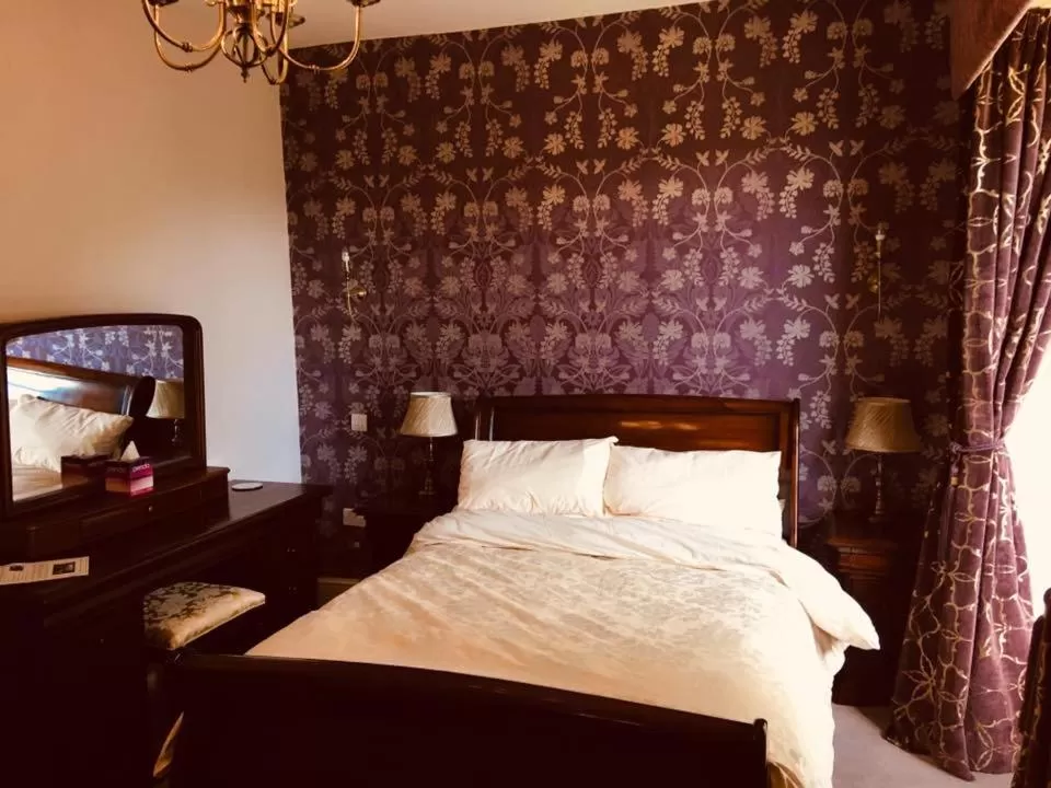Bed in Brass Castle Country House Accommodation