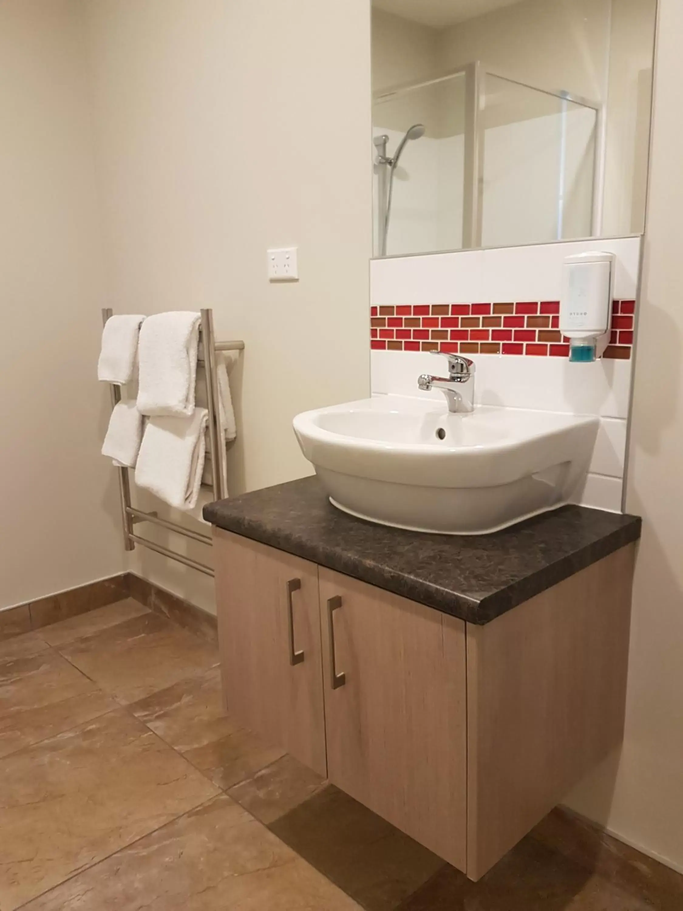 Bathroom in Ramada Suites by Wyndham Christchurch City