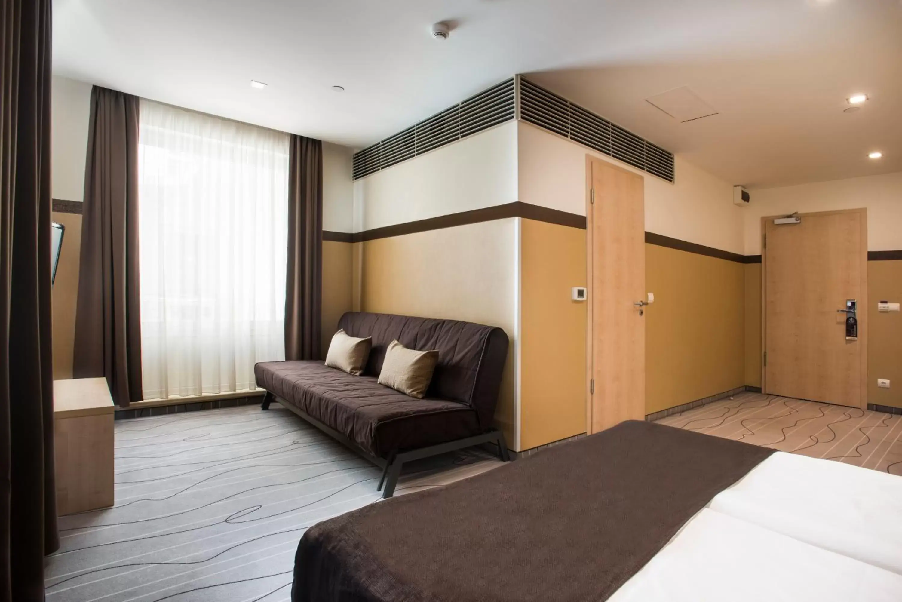 Bedroom, Seating Area in Promenade City Hotel