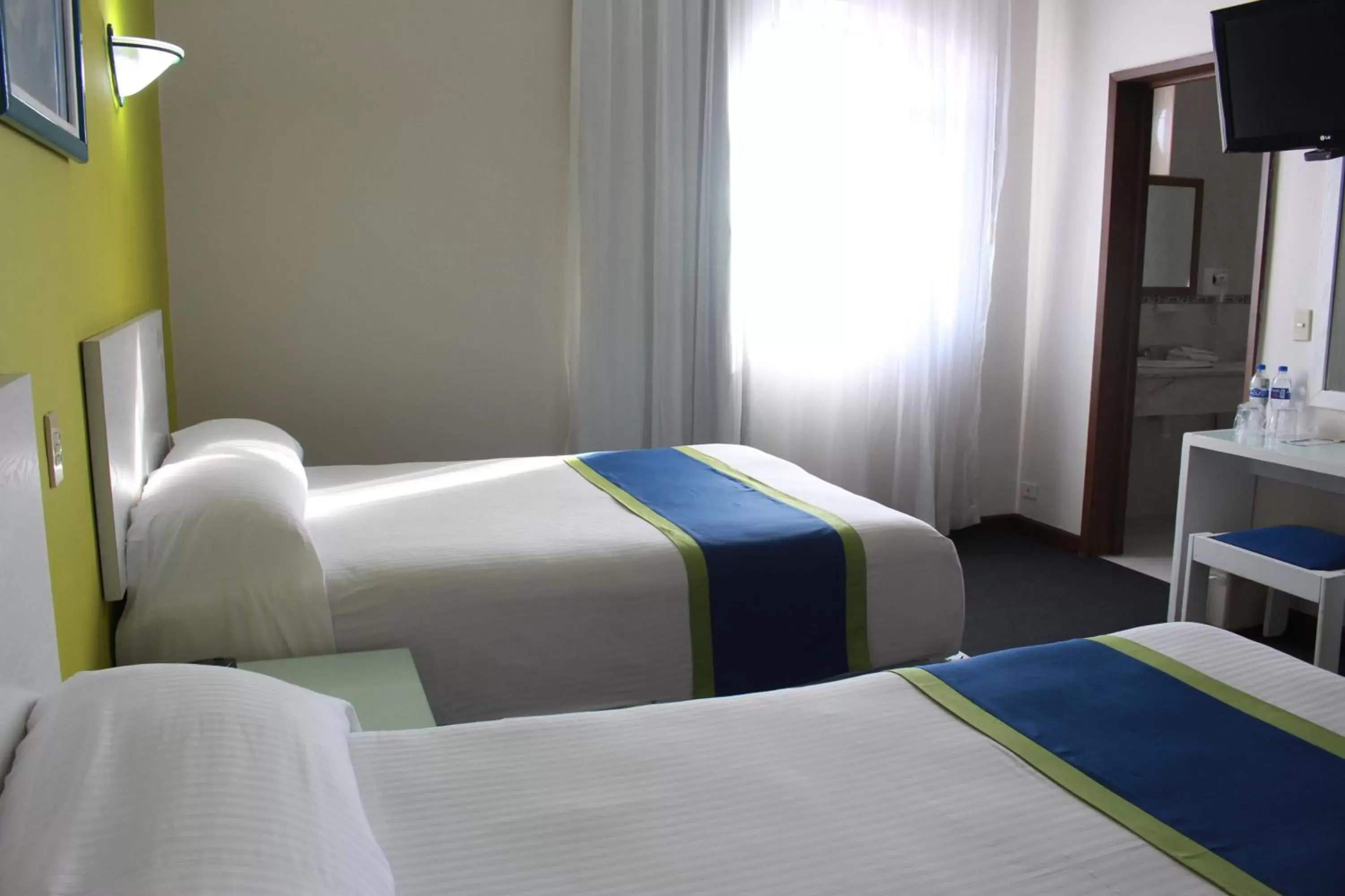 Photo of the whole room, Bed in Vista Express Morelia by Arriva Hospitality Group