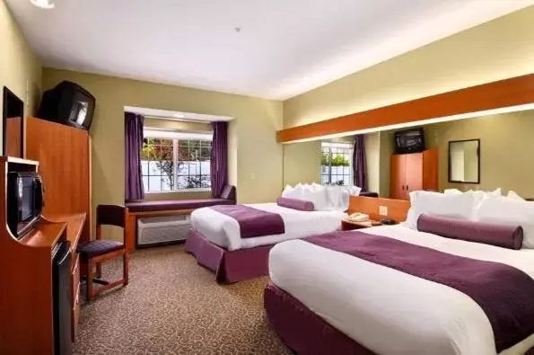 Bed in Stay Beyond Inn & Suites