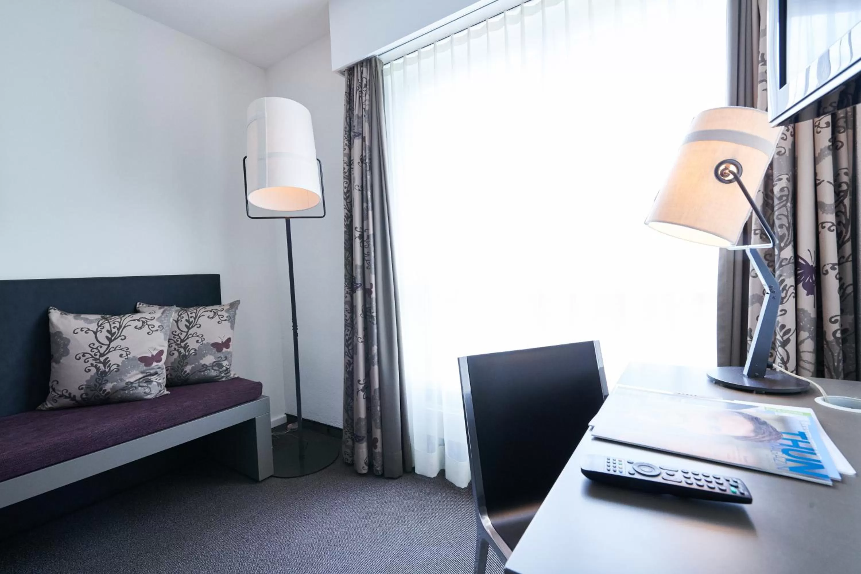 Seating area, Bed in Hotel Holiday Thun