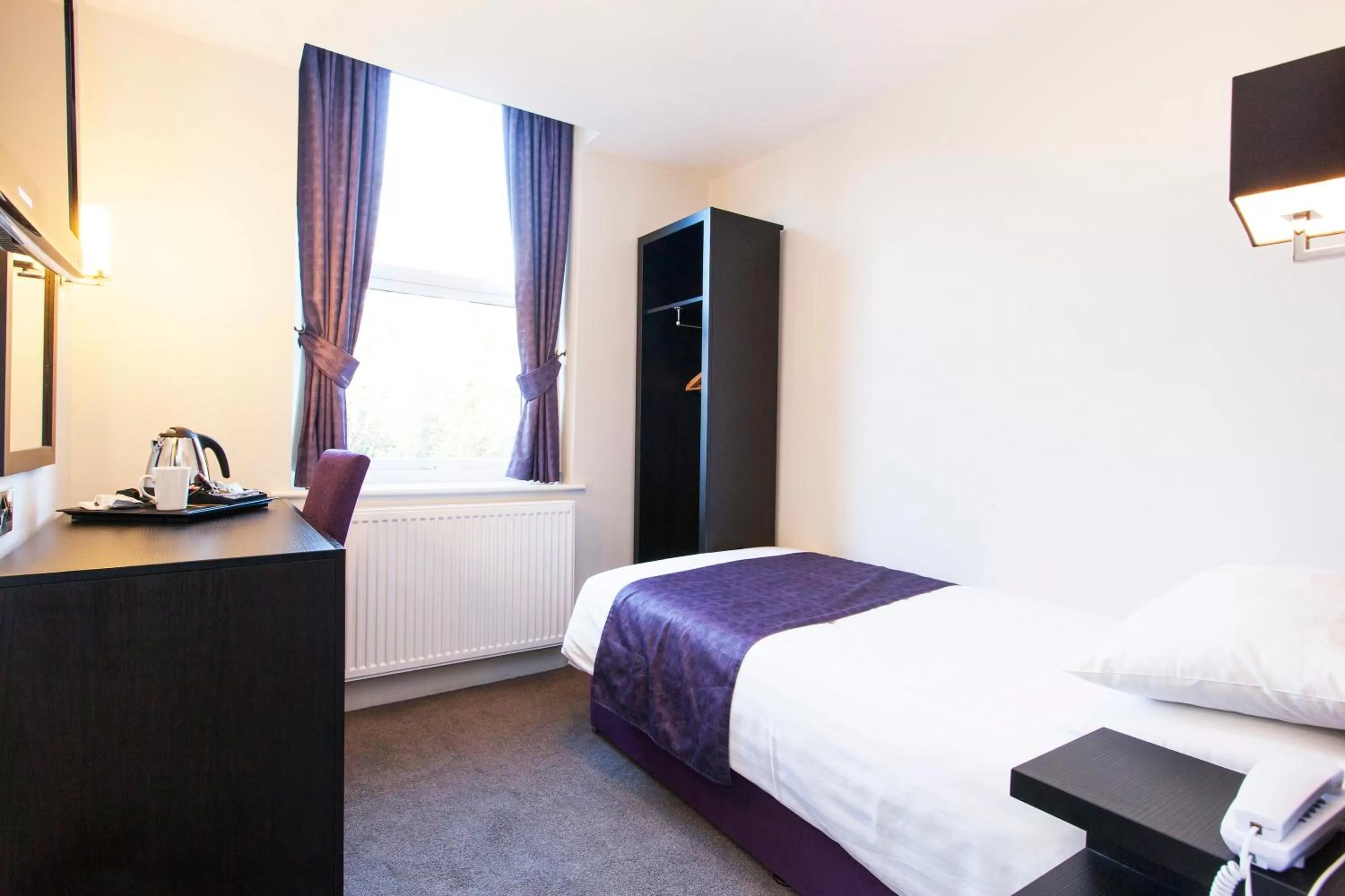 Bed in The Abbey Lodge Hotel