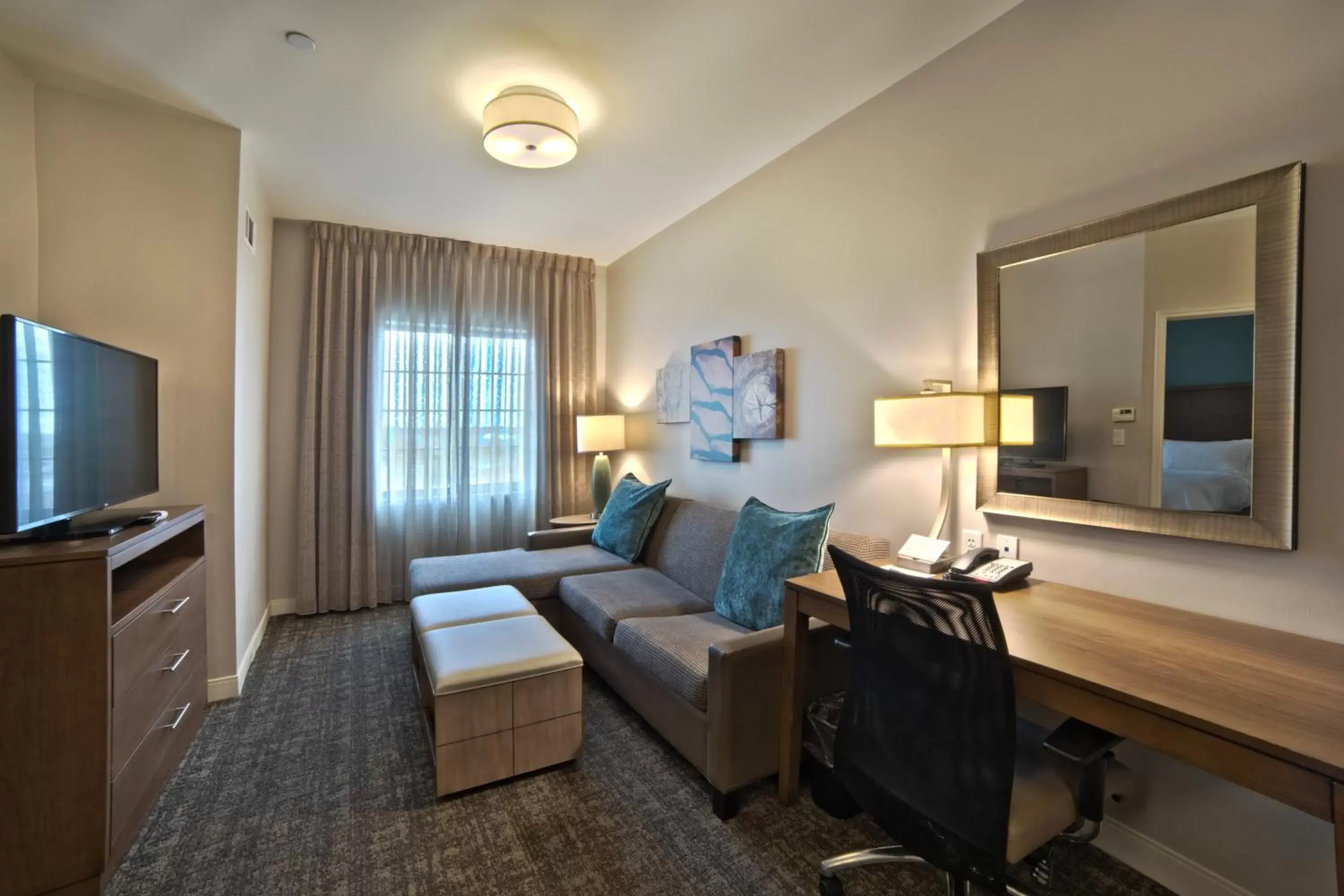 Living room, TV/Entertainment Center in Staybridge Suites Houston - Humble Beltway 8 E, an IHG Hotel