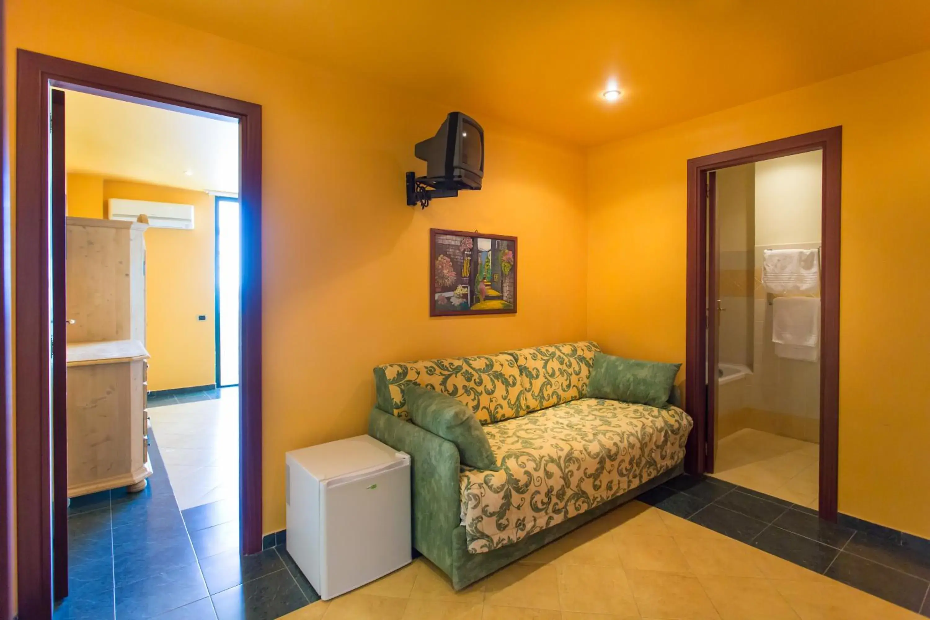 Bed, Seating Area in La Playa Blanca Hotel & Ristorante