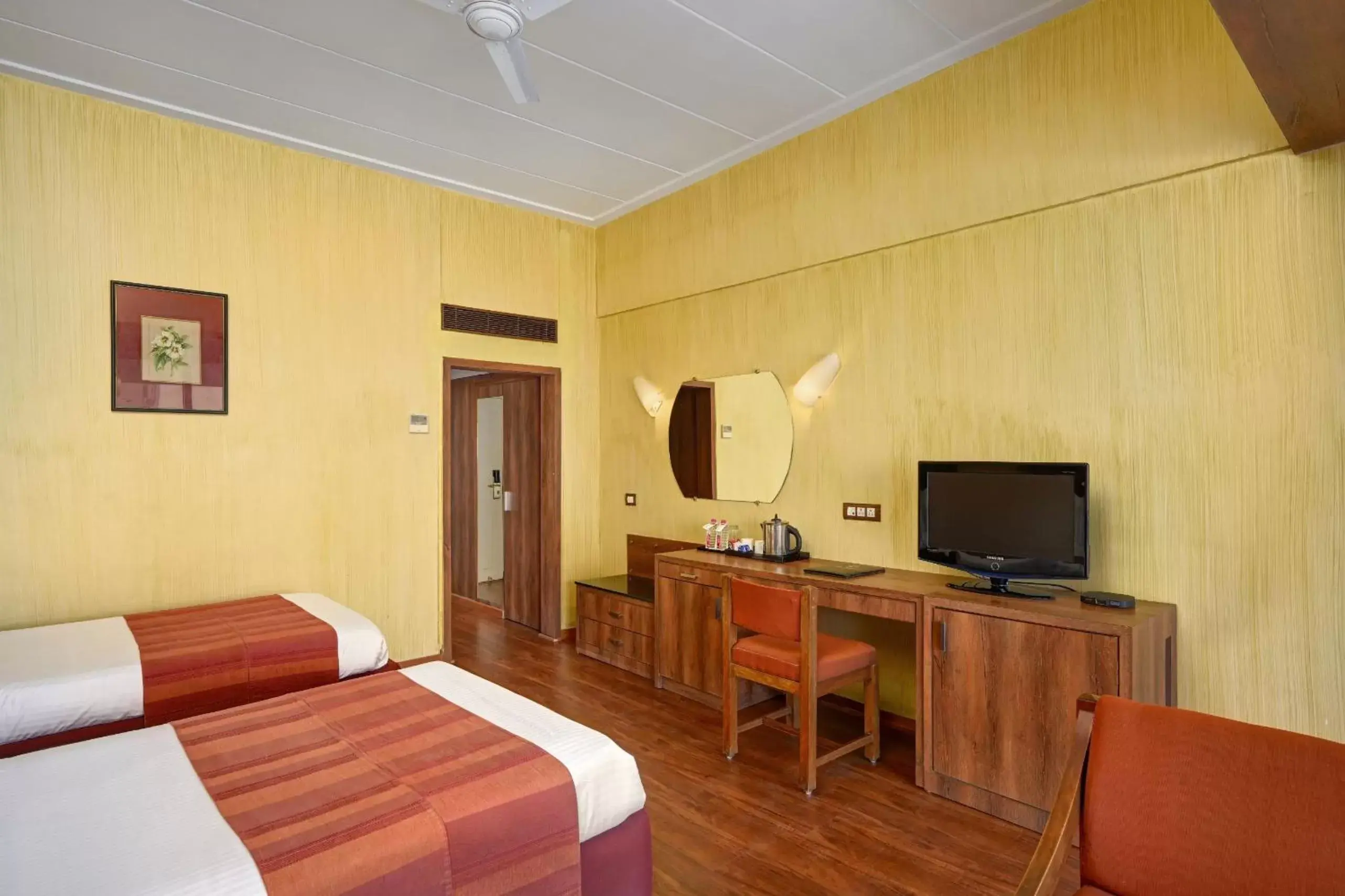 Bed, TV/Entertainment Center in The Cama - A Sabarmati Riverfront Hotel