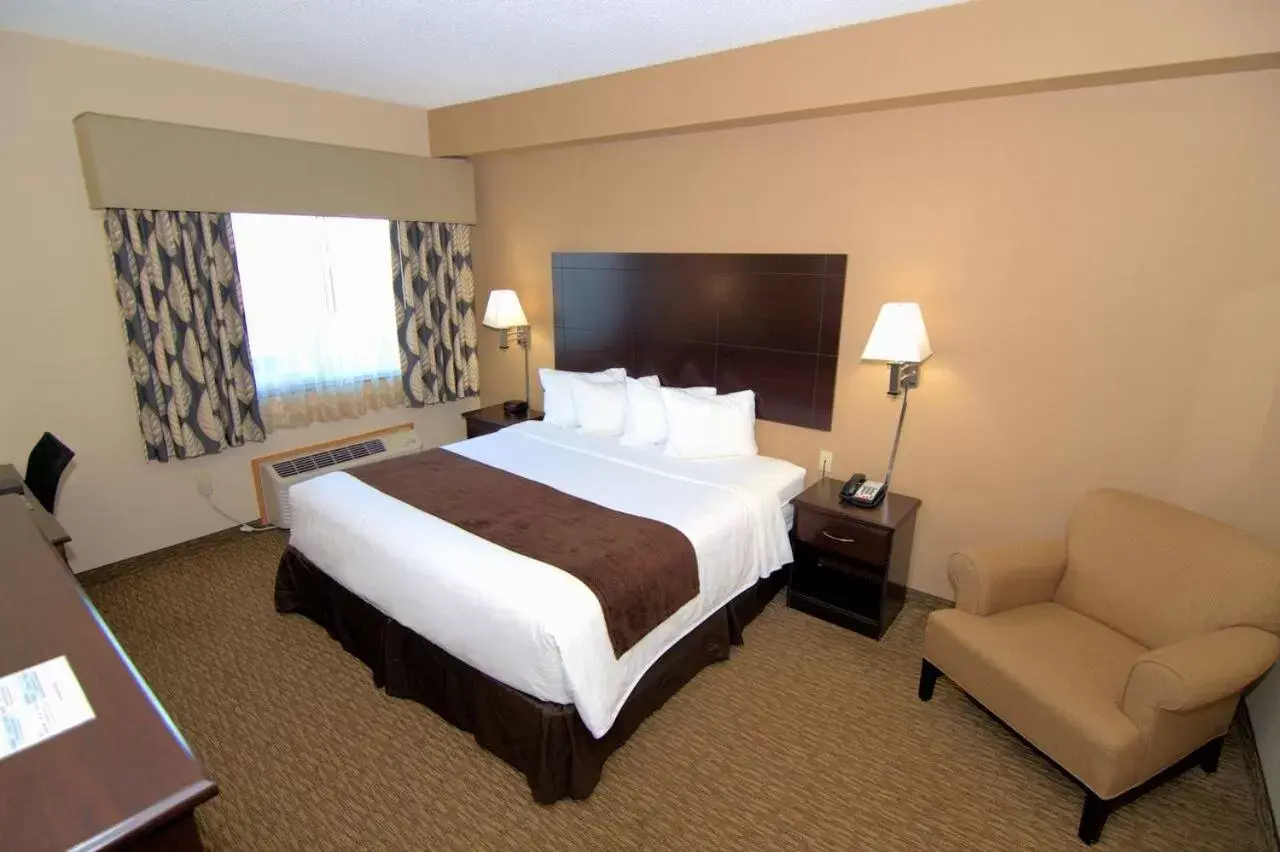 Bed in Rock Island Inn & Suites