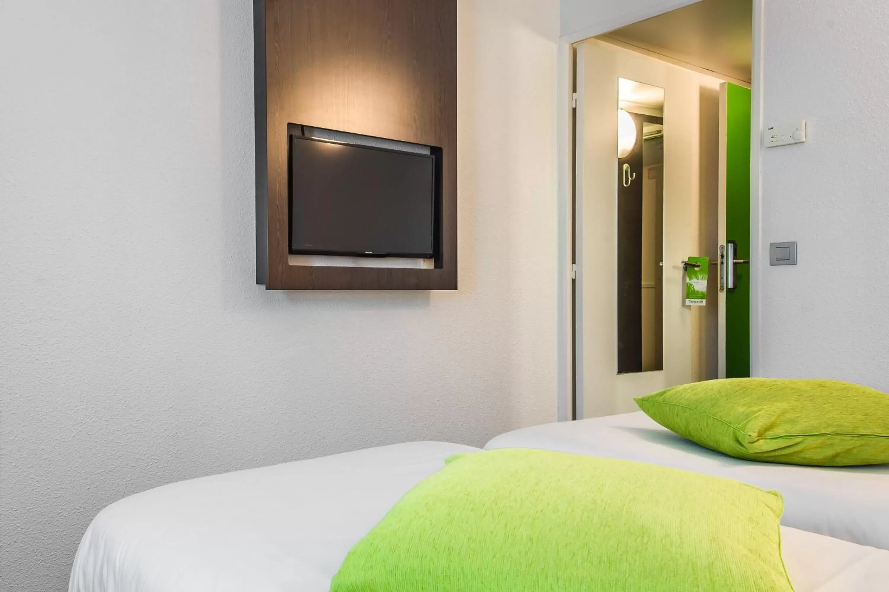 Bed, TV/Entertainment Center in Mandarina Hotel Luxembourg Airport