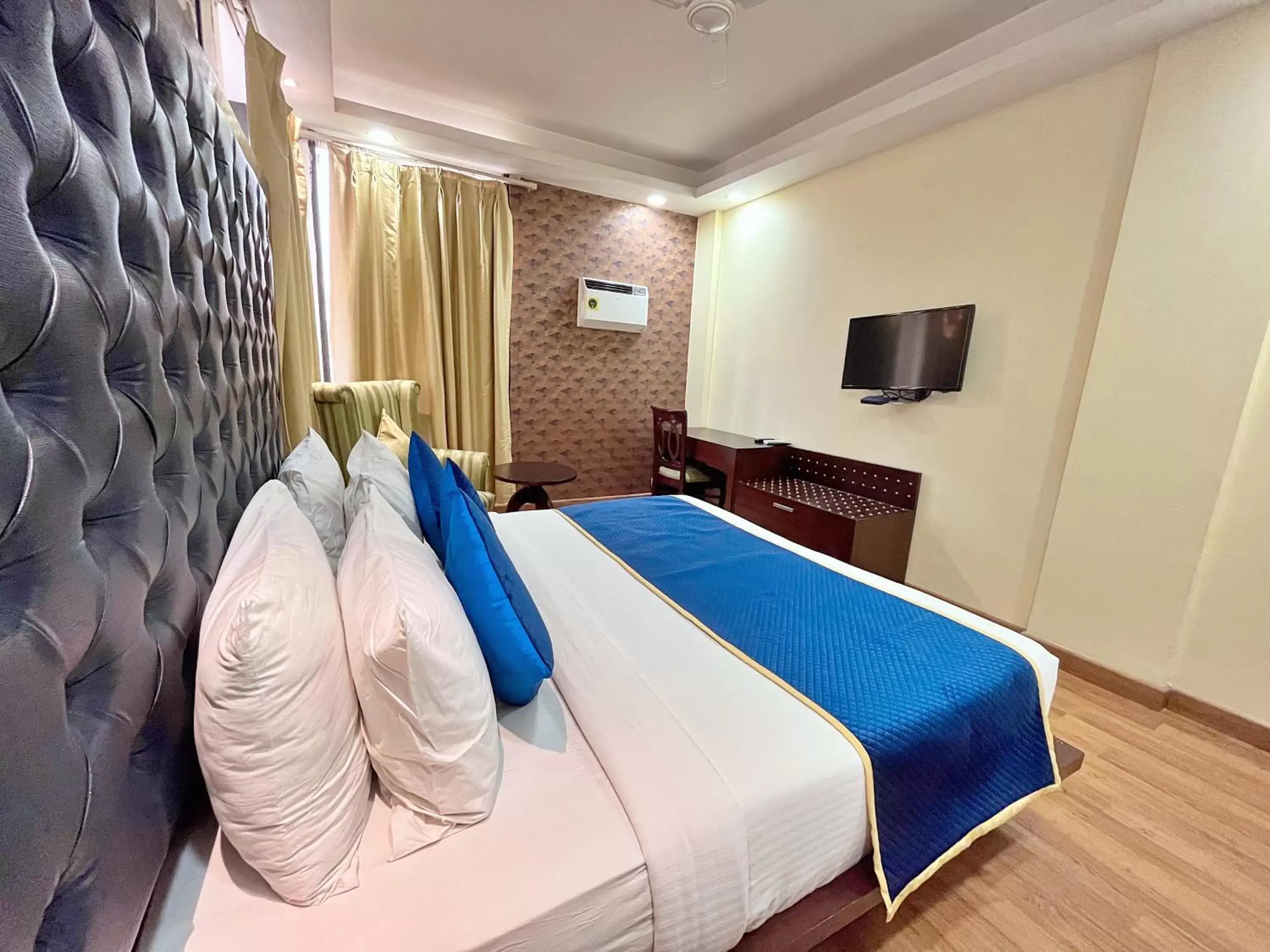 Bed in The Grand Orion - Kailash Colony