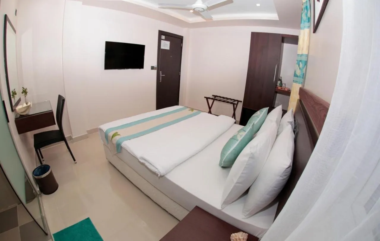 Bed in The White Harp Beach Hotel