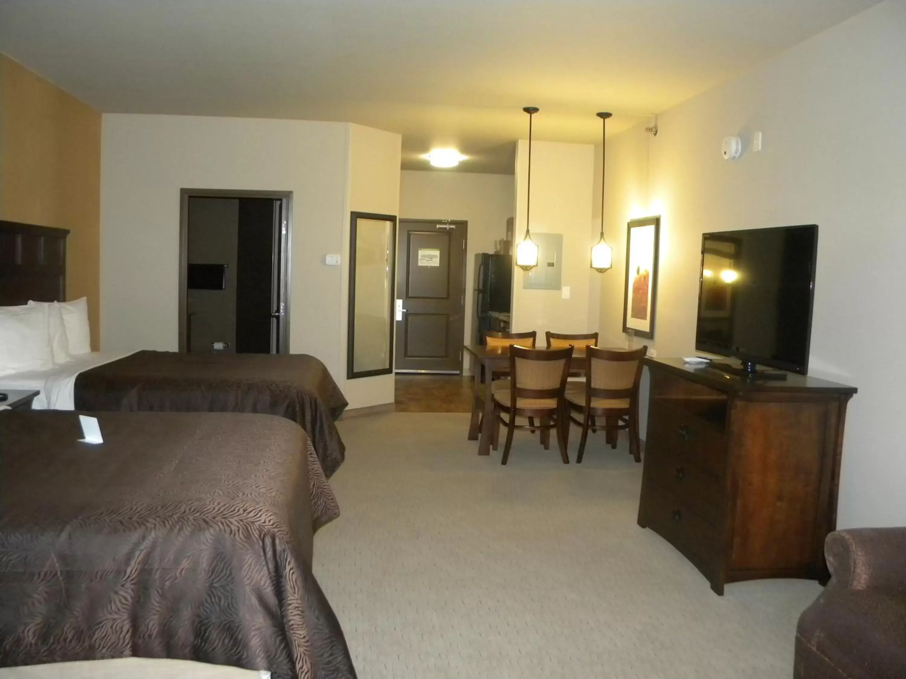 Bed, TV/Entertainment Center in Teddy's Residential Suites Watford City