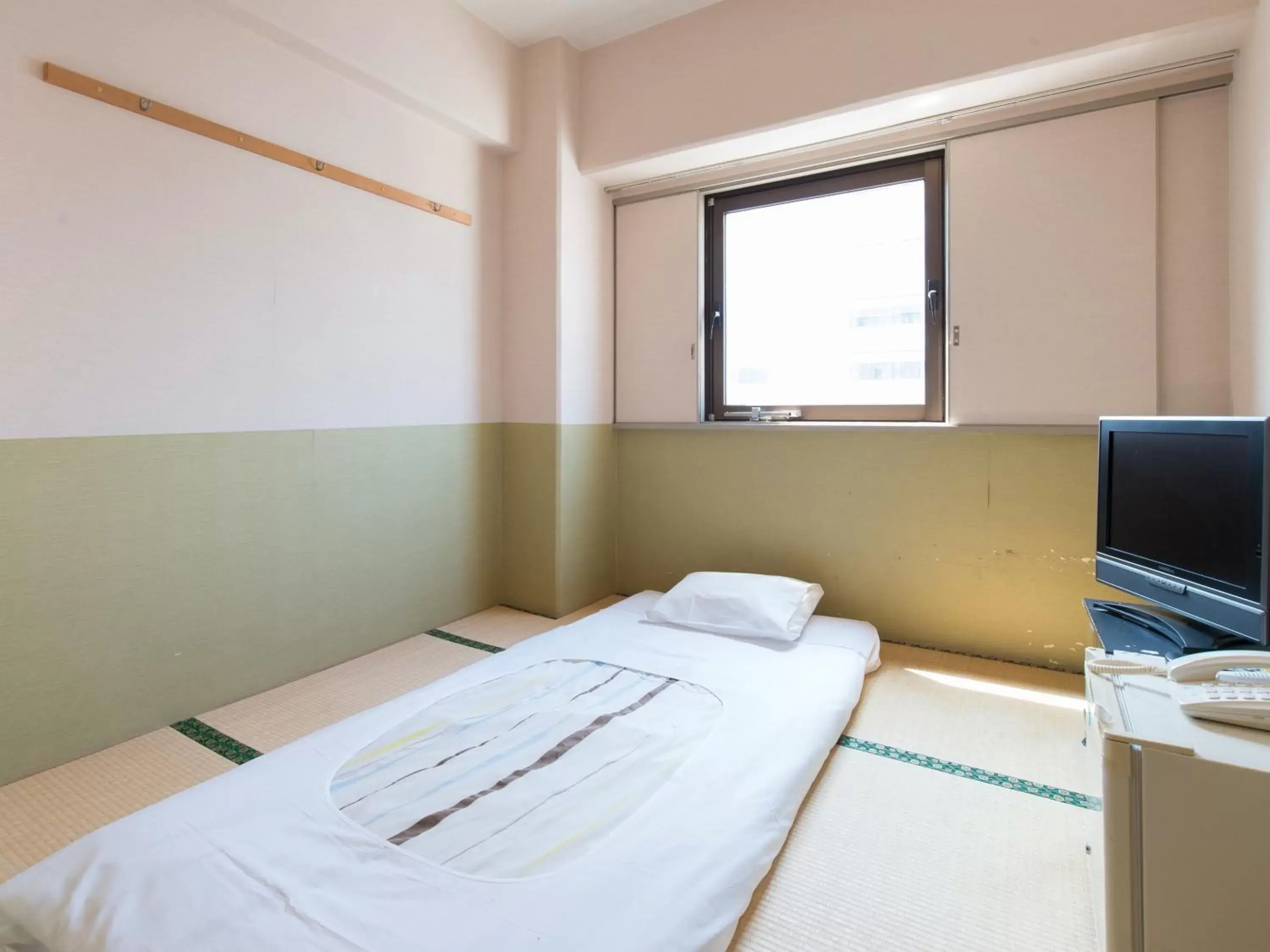 Bed in Tabist Hotel Tetora Kitakyushu