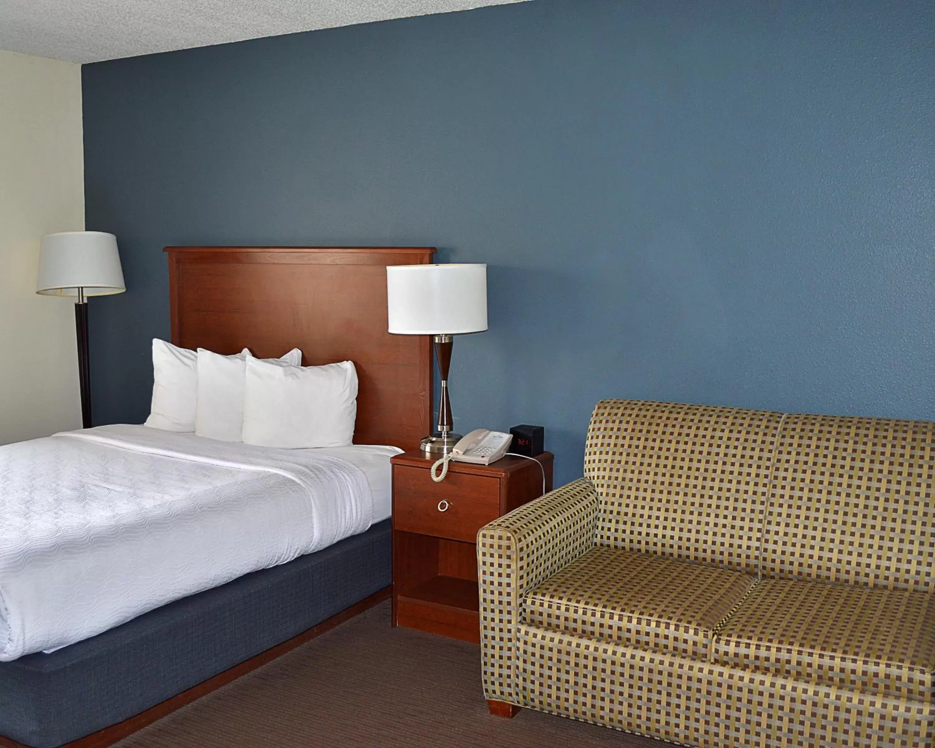 Bed in AmericInn by Wyndham Spencer