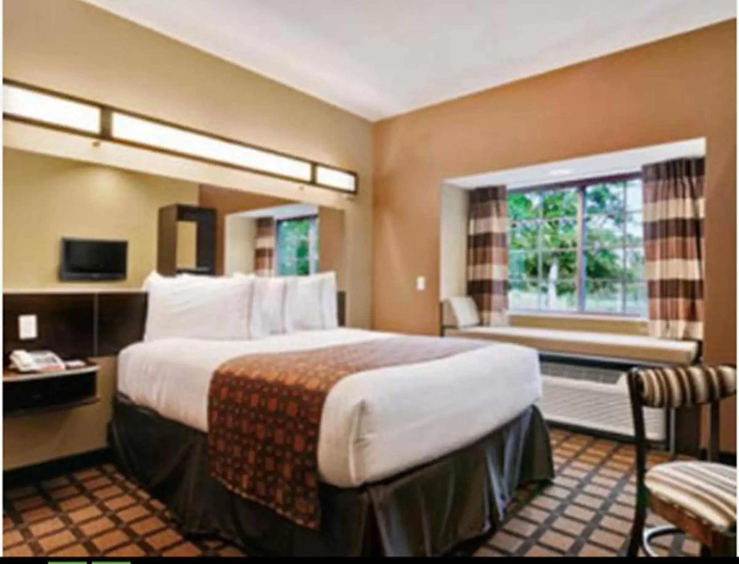 Bed in Microtel Inn & Suites by Wyndham Ozark