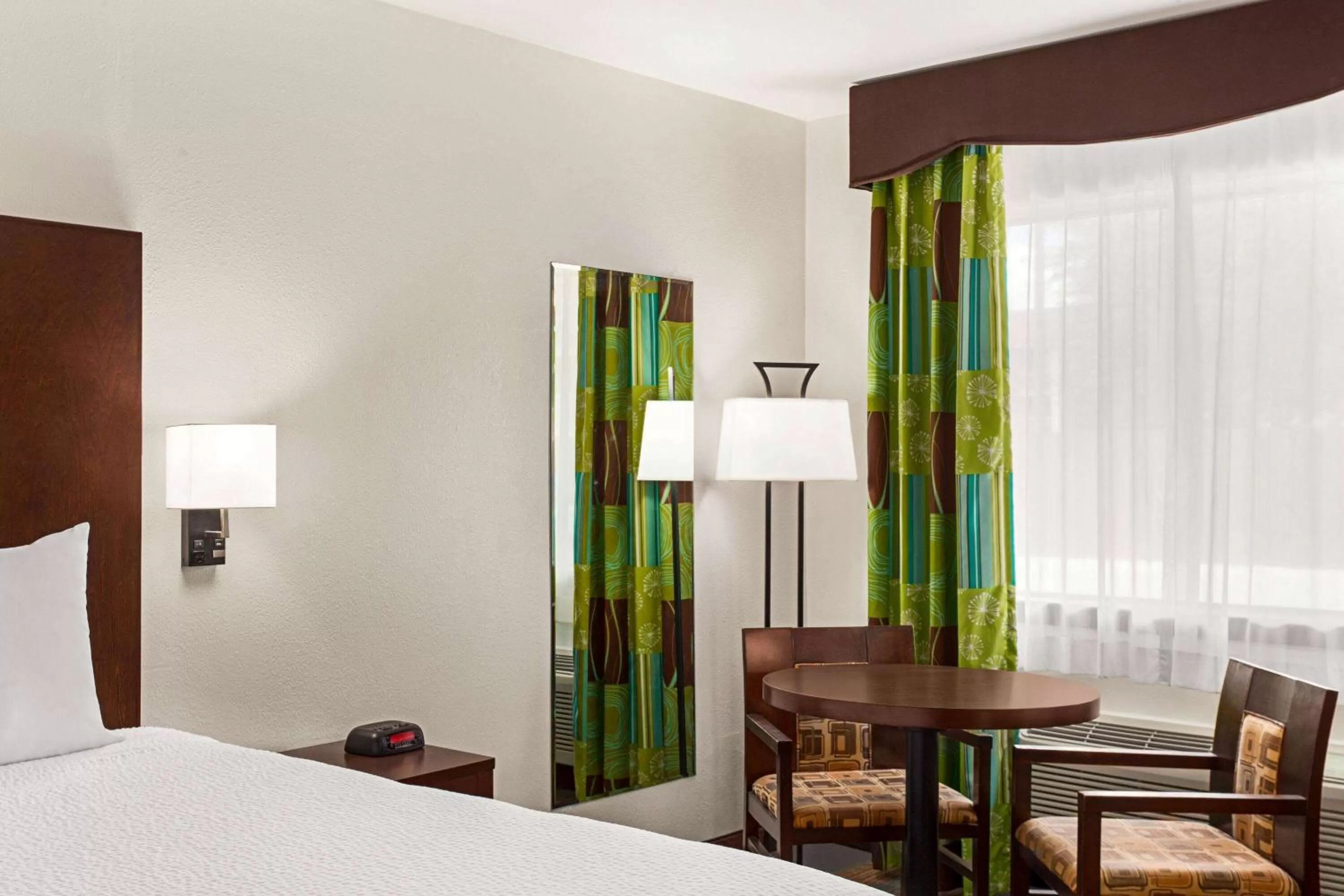 Seating area, Bed in Ramada by Wyndham San Antonio Near SeaWorld - Lackland AFB