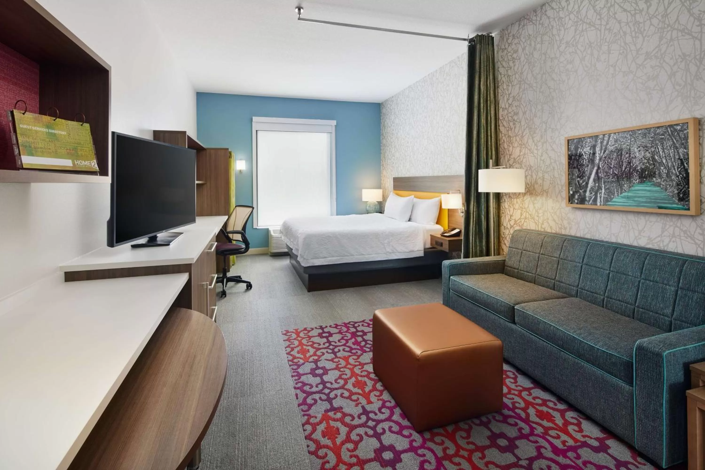 Living room, Bed in Home2 Suites By Hilton Stuart