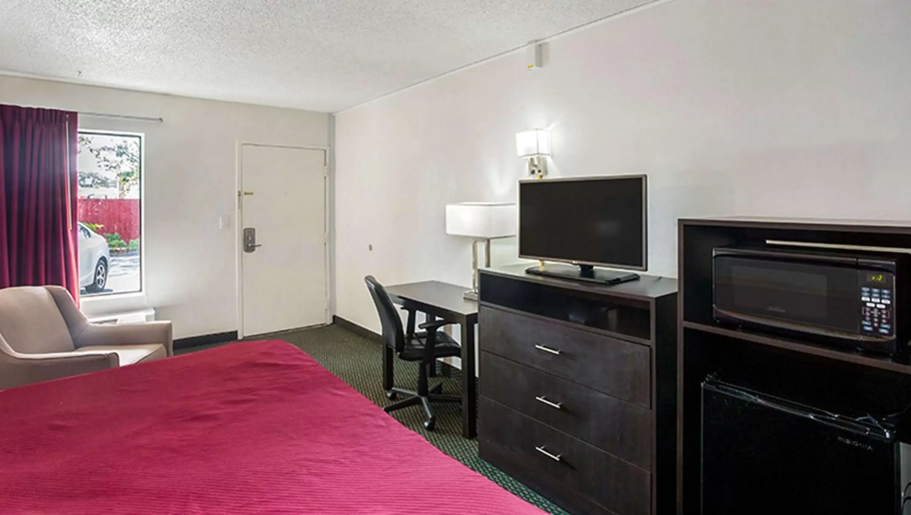 Photo of the whole room, TV/Entertainment Center in Magnuson Hotel Bradenton