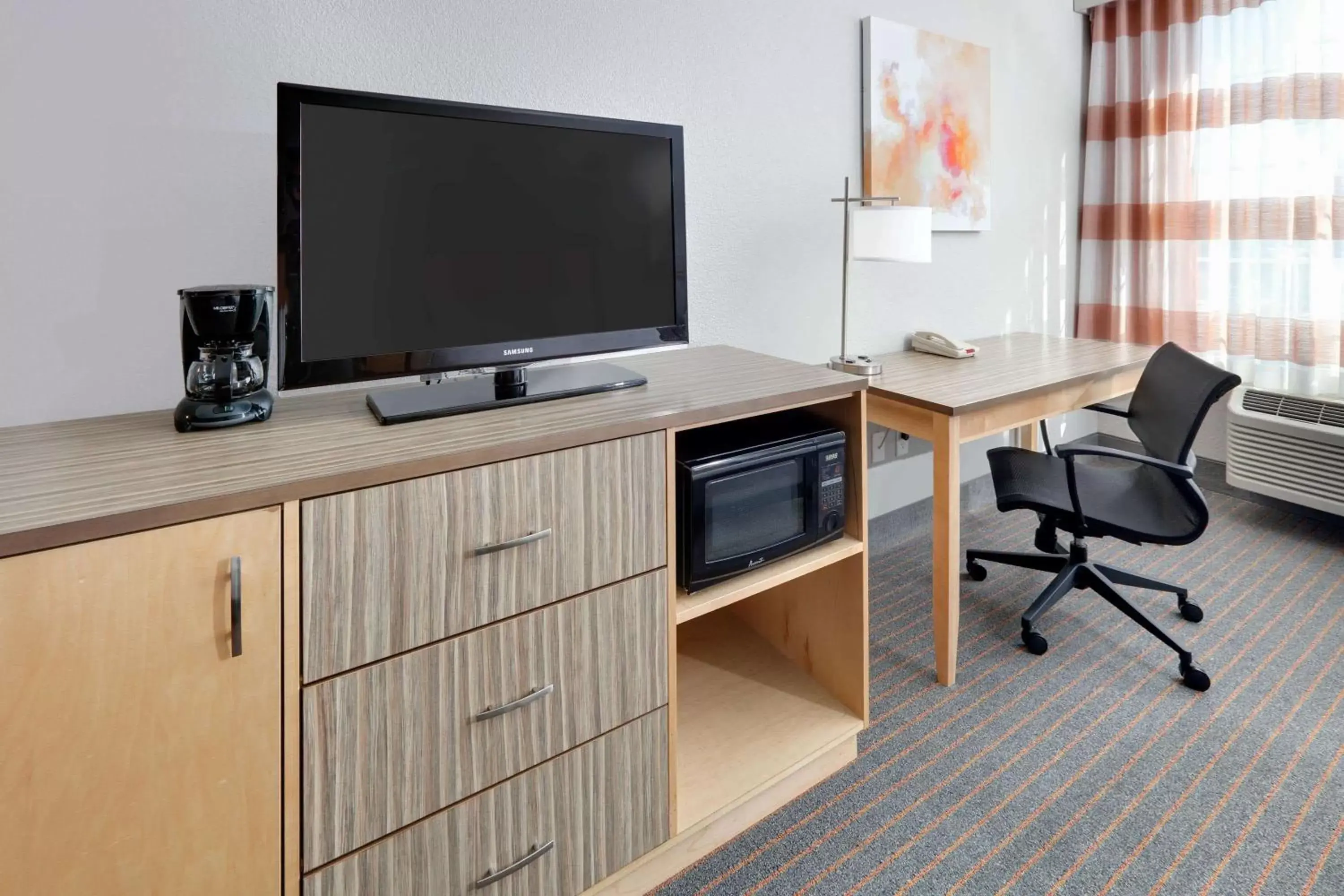 Photo of the whole room, TV/Entertainment Center in La Quinta by Wyndham Dallas Love Field