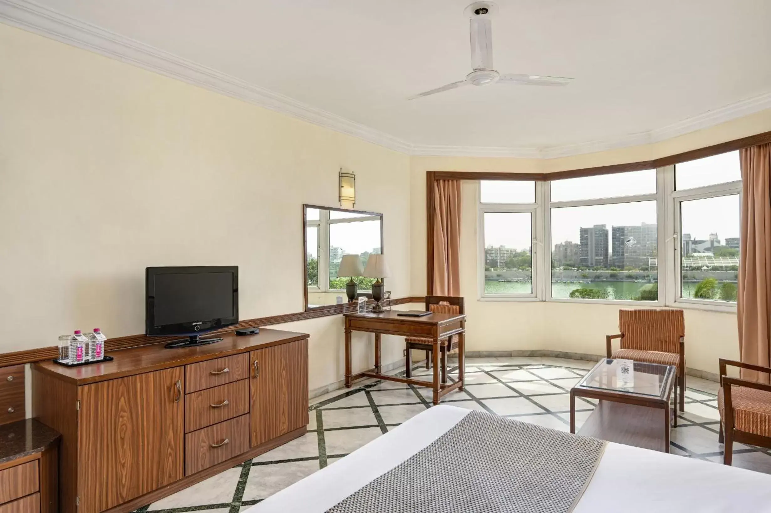 Bed, TV/Entertainment Center in The Cama - A Sabarmati Riverfront Hotel