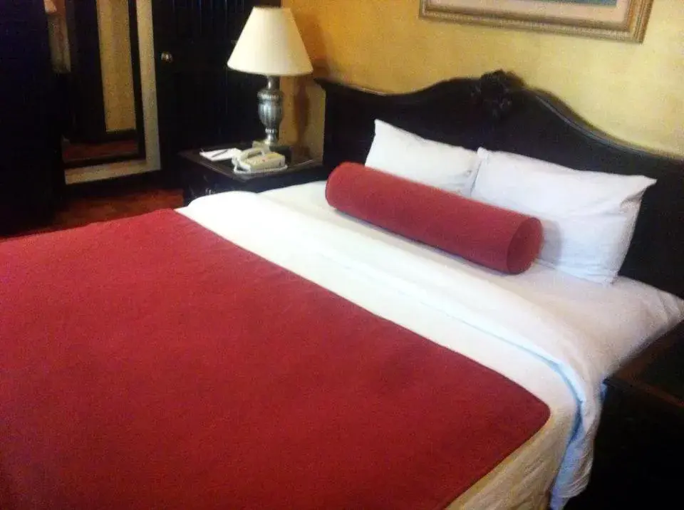 Bed in Lourdes Suites