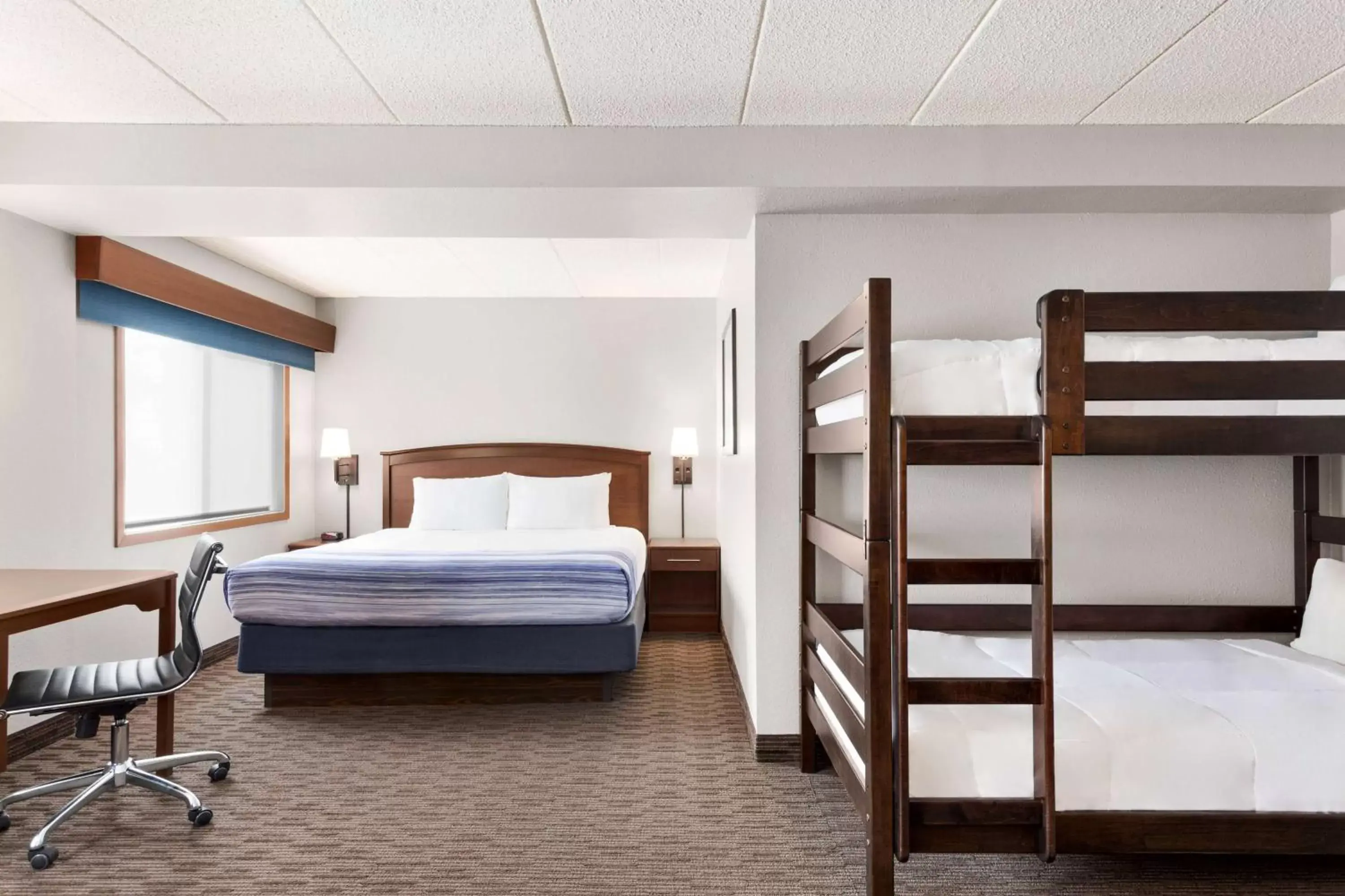 Bed in AmericInn by Wyndham Sauk Centre