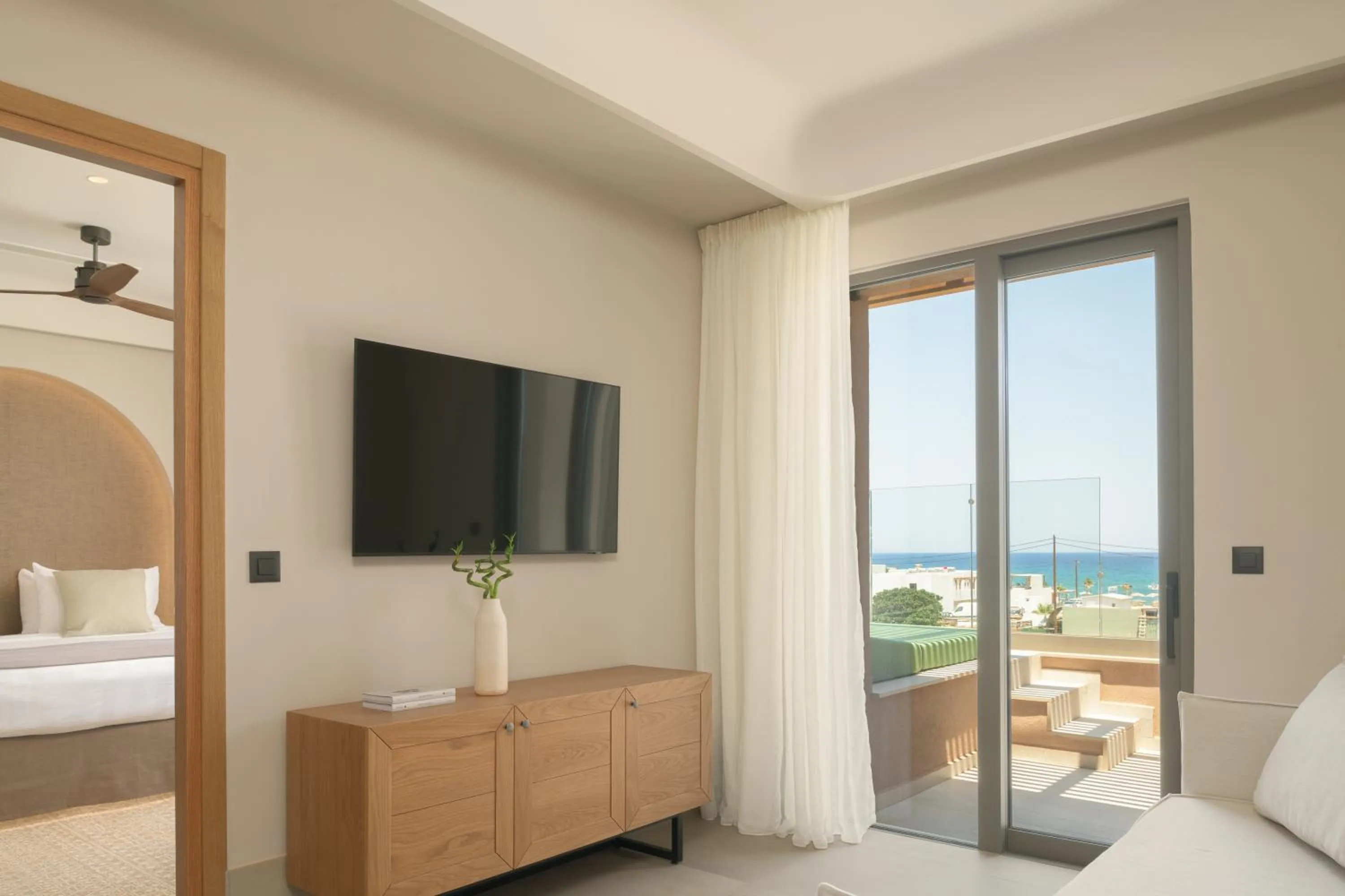 Communal lounge/ TV room, Bed in Paralos Venus Suites Adults Only