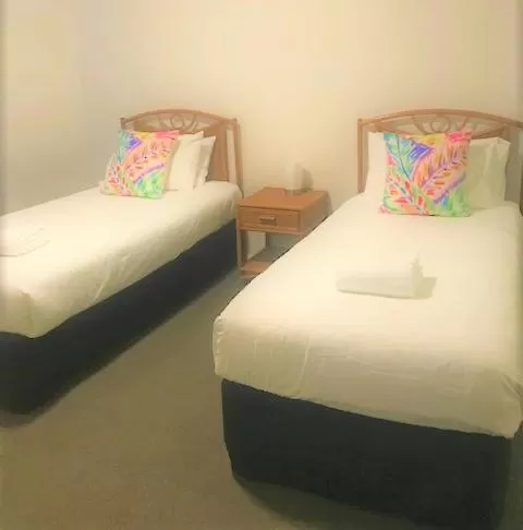 Bed in Sunrise Luxury Apartments