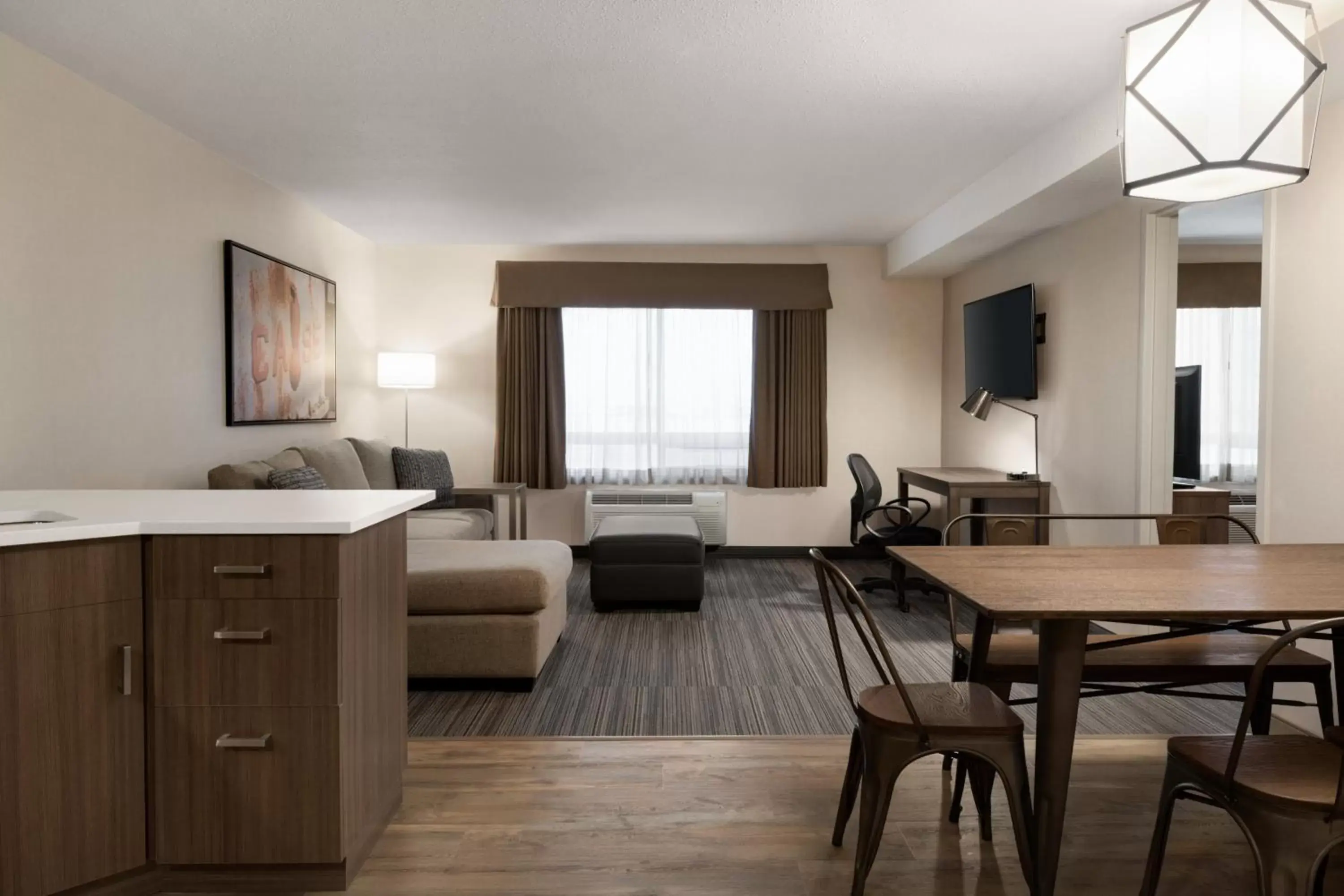 Living room, Seating Area in Ramada by Wyndham Airdrie Hotel & Suites