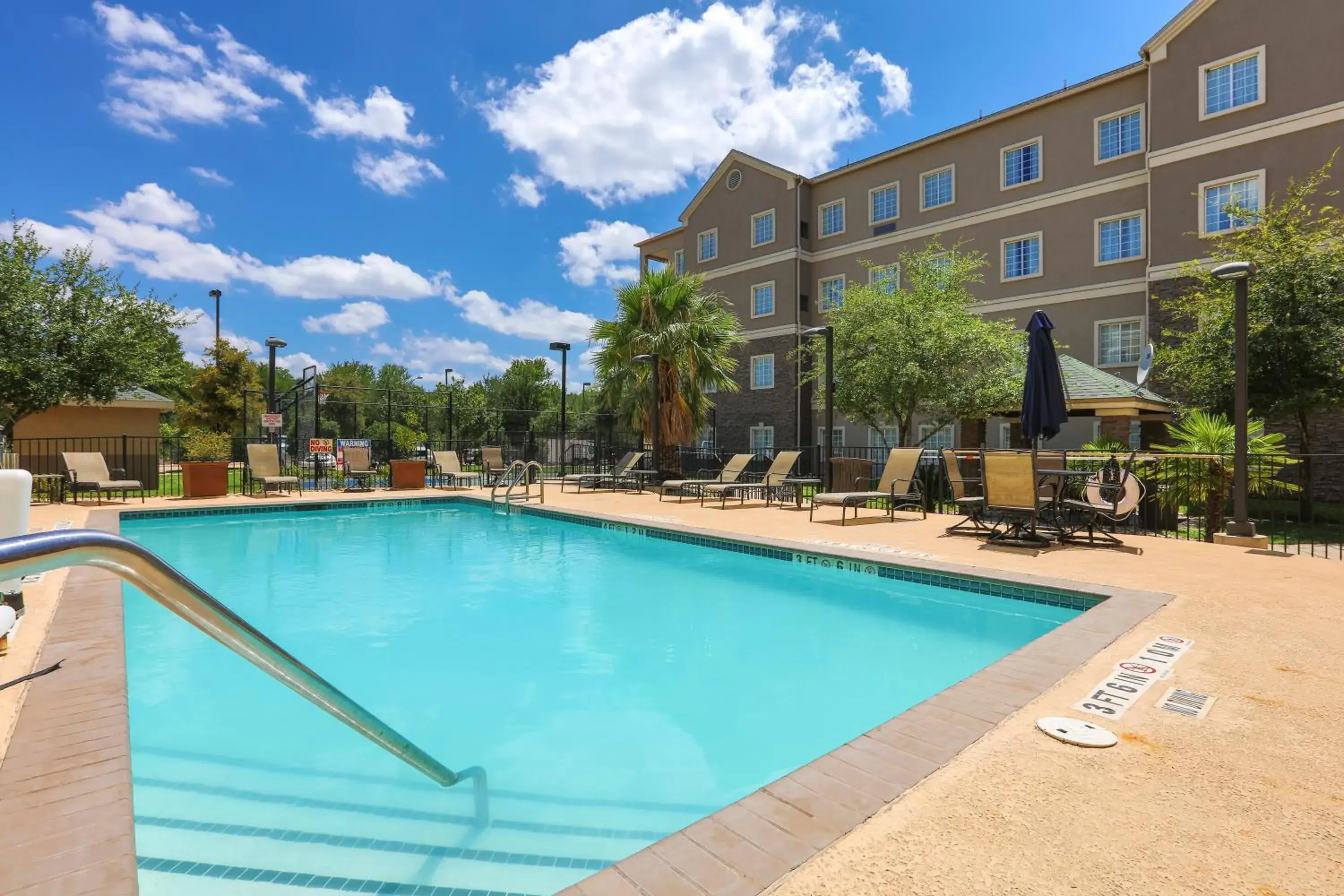 Swimming pool, Property Building in Staybridge Suites Austin Airport, an IHG Hotel