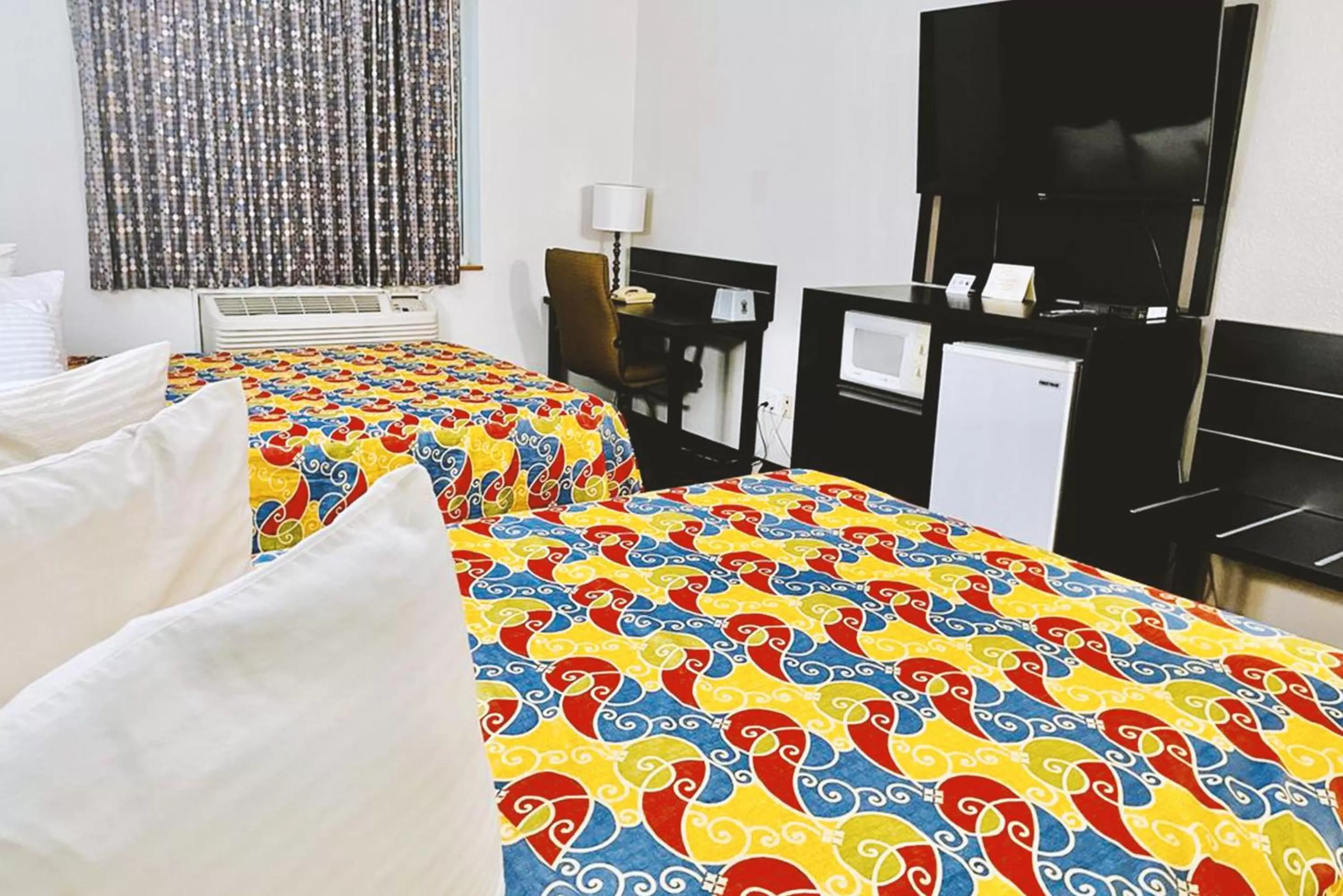 Bed in Coratel Inn & Suites by Jasper Northfield