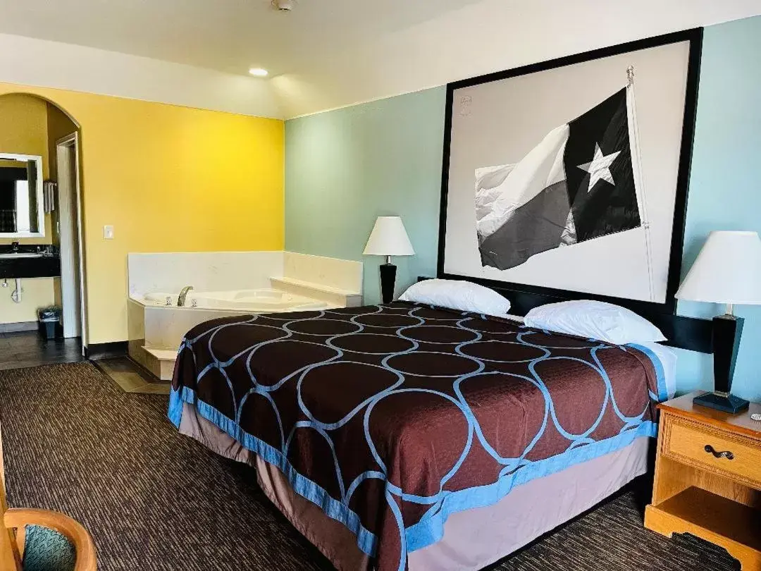 Bed in Super 8 by Wyndham Montgomery/ Lake Conroe